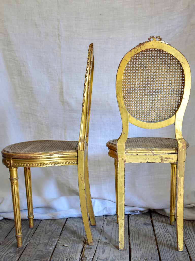 Pair of 18th Century Louis XVI gilded cane chairs