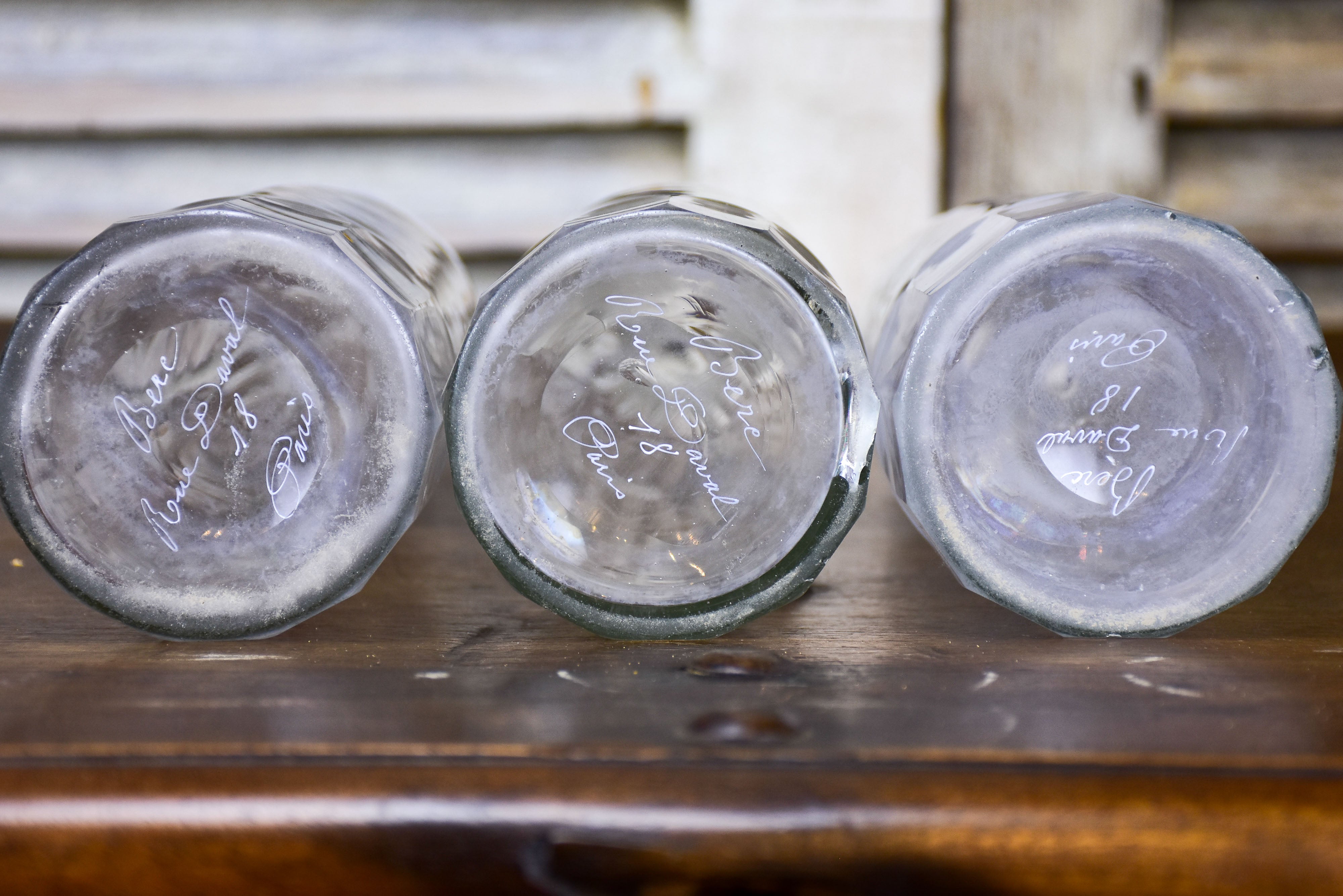 Three antique Parisian bistro bottles - signed