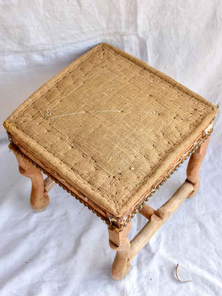 Rustic antique French stool with jute upholstery