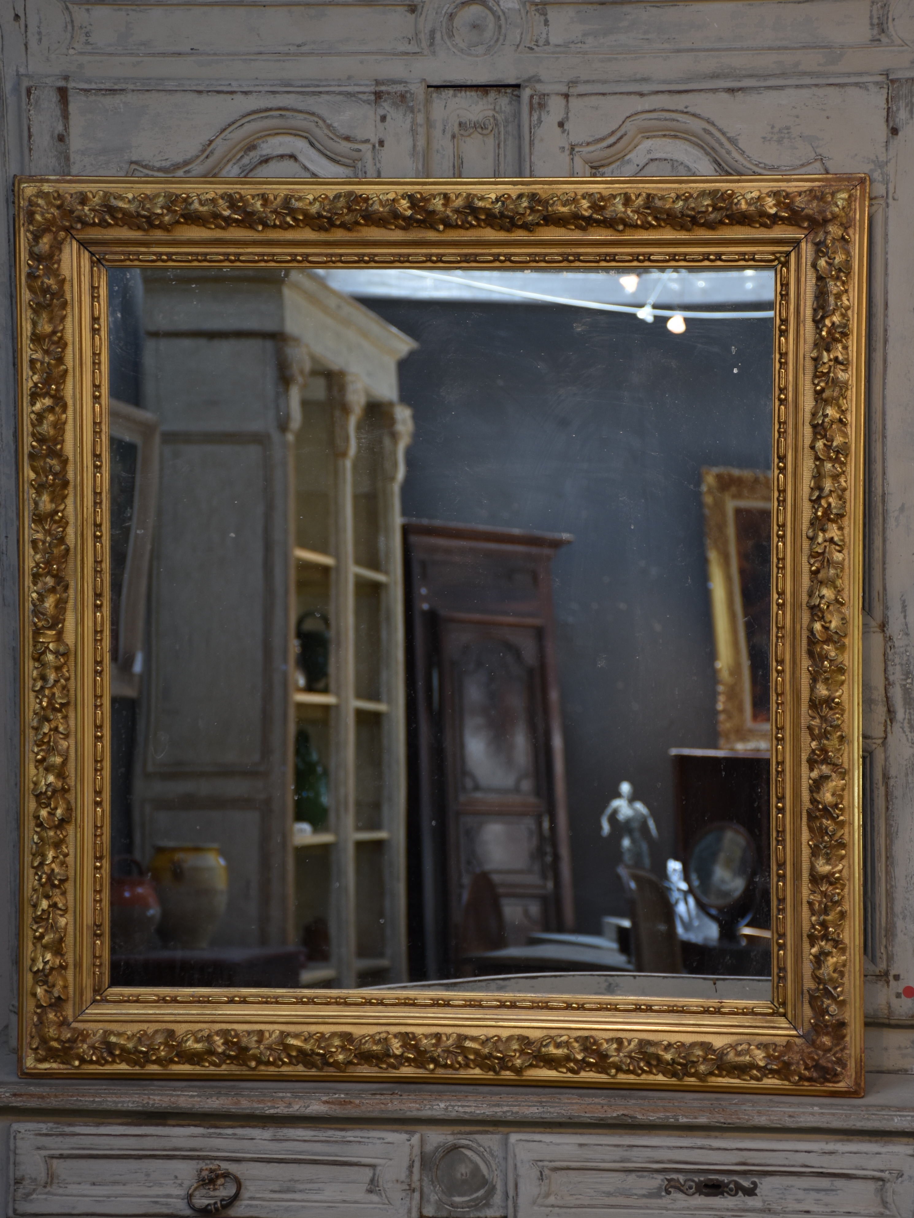 Large square gilded French mirror with sculptural oak leaf frame