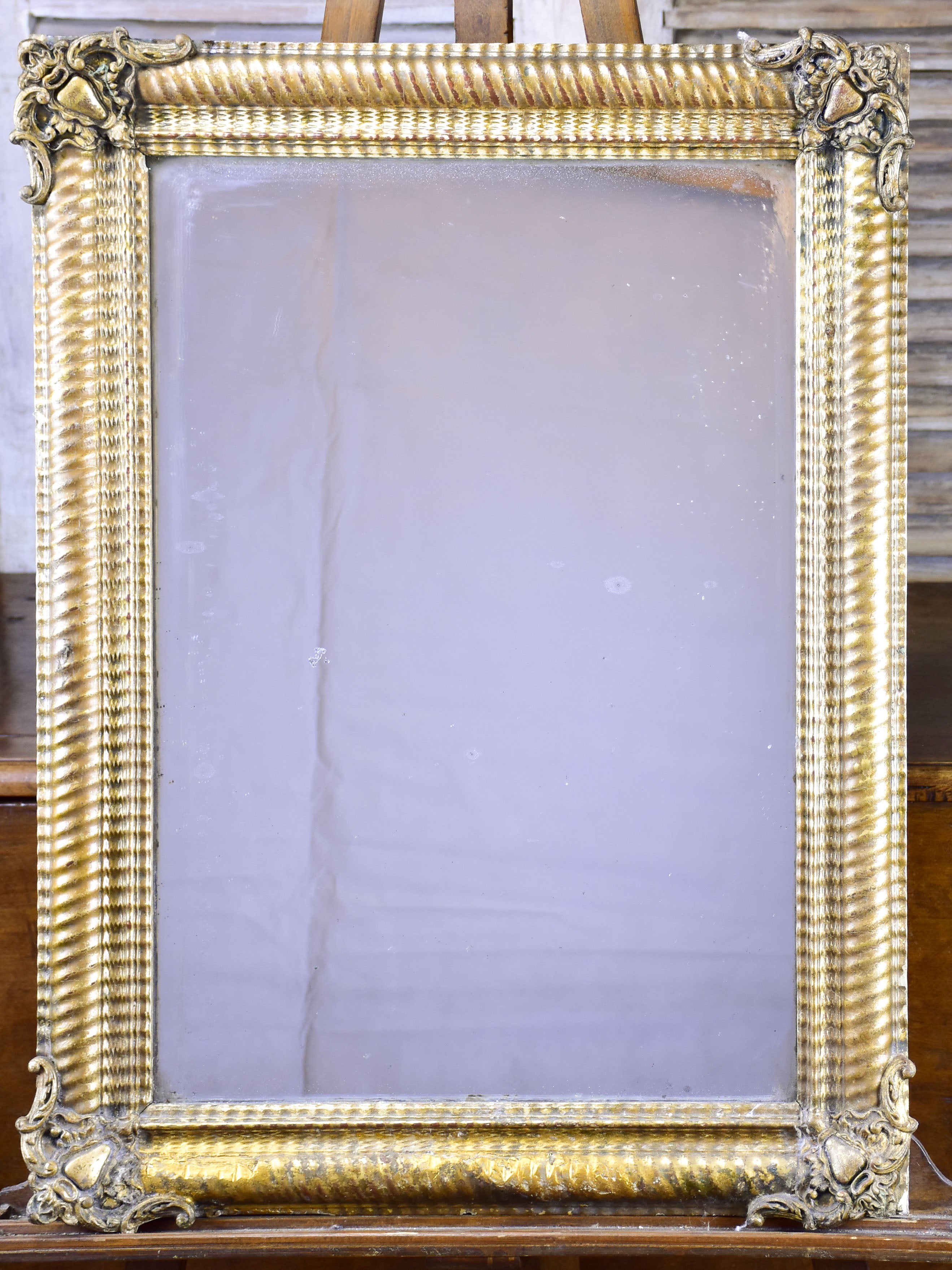 Antique French mirror with gold gadrooned frame