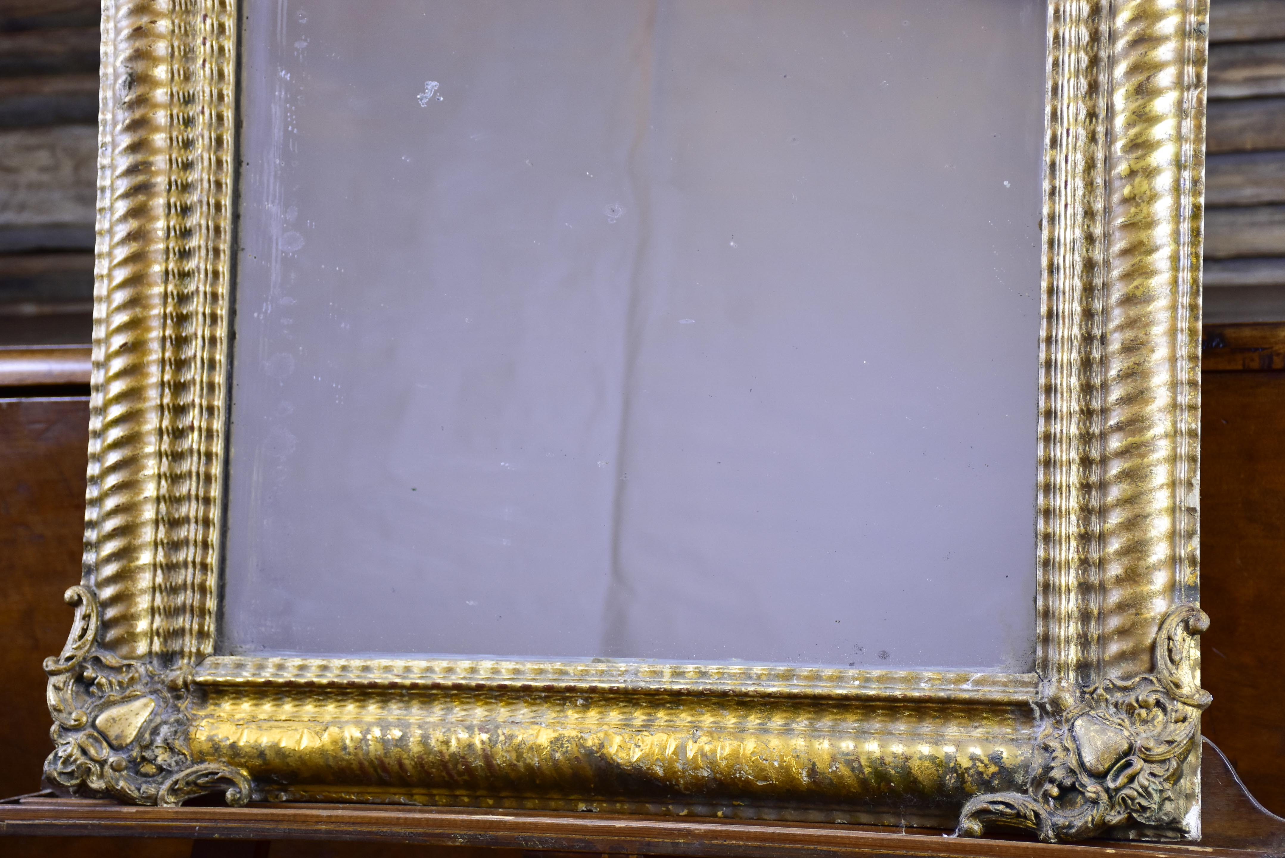 Antique French mirror with gold gadrooned frame