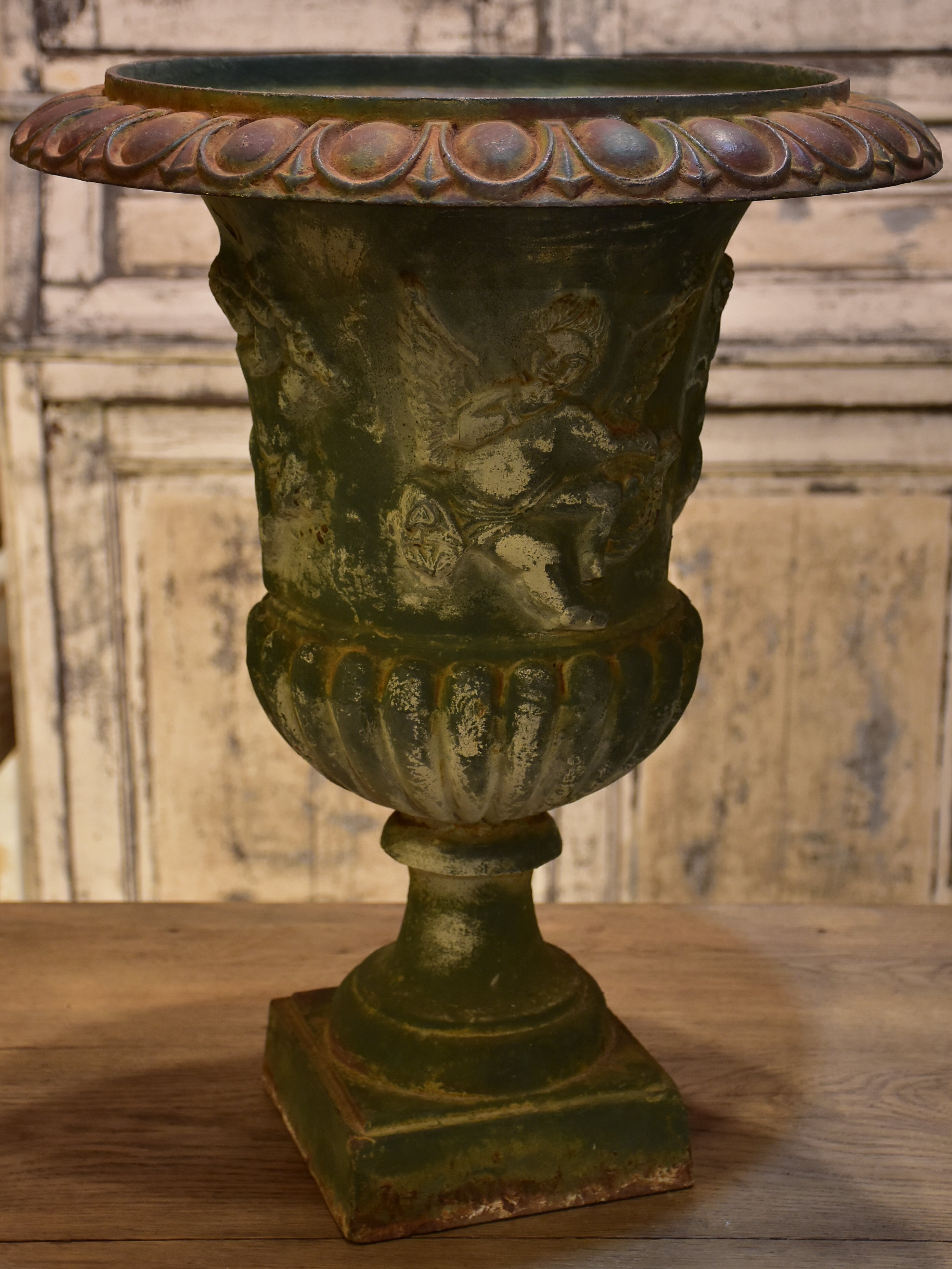 Late 19th century garden urn with angels and green patina