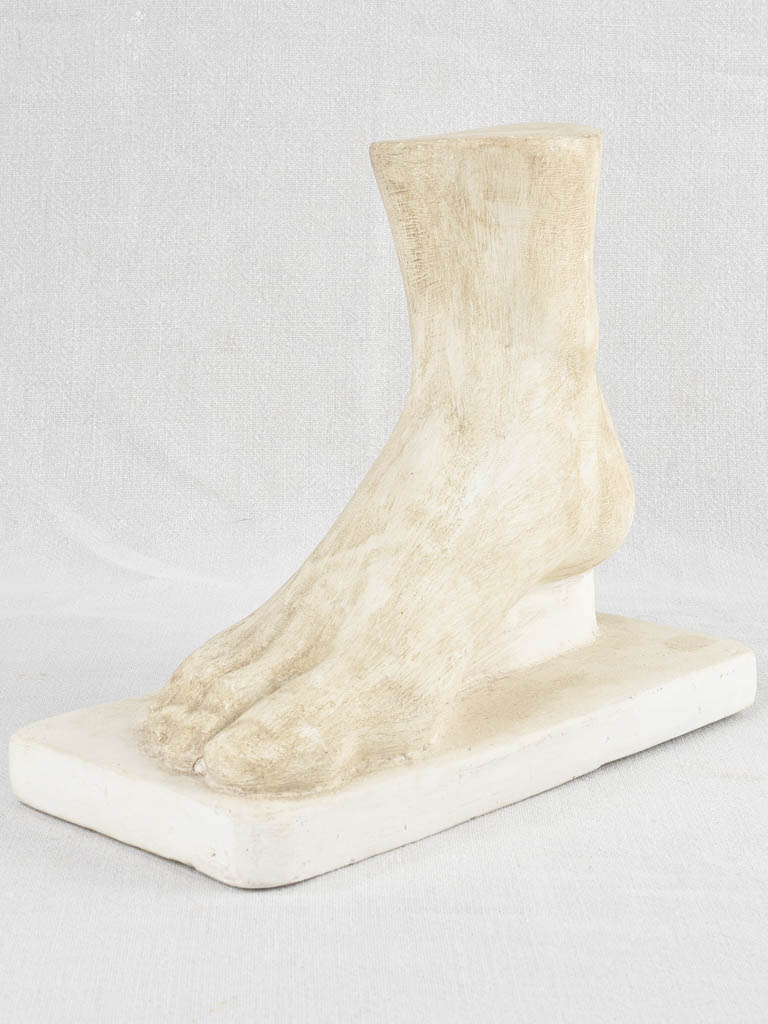 Retro plaster foot molding on base