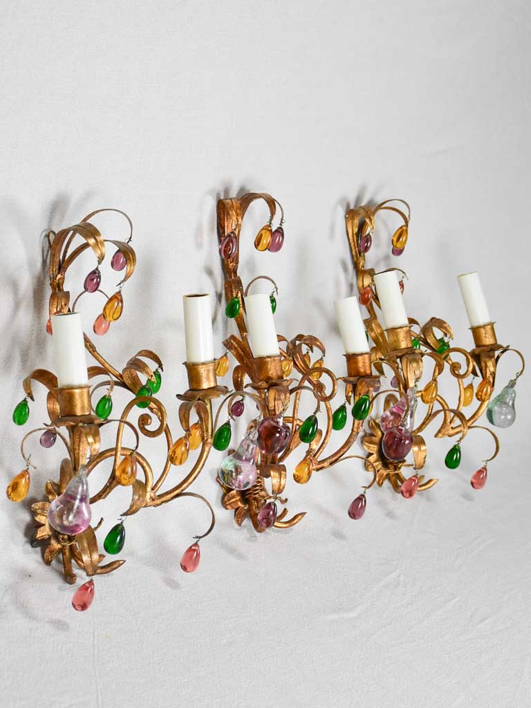 Three gold 1950s wall sconces with colorful glass fruits and pendants 13¾"