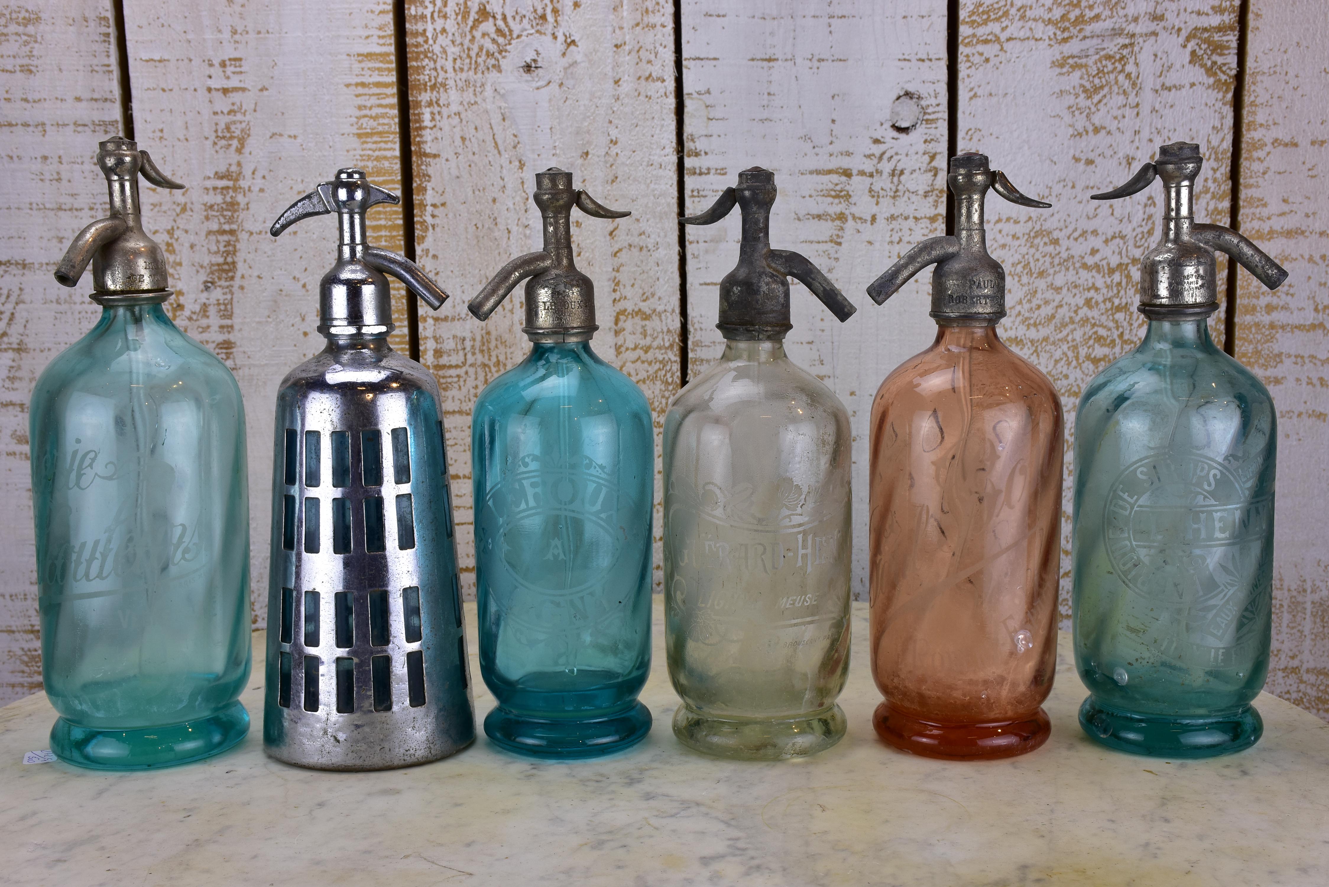 Twelve antique French seltzer bottles