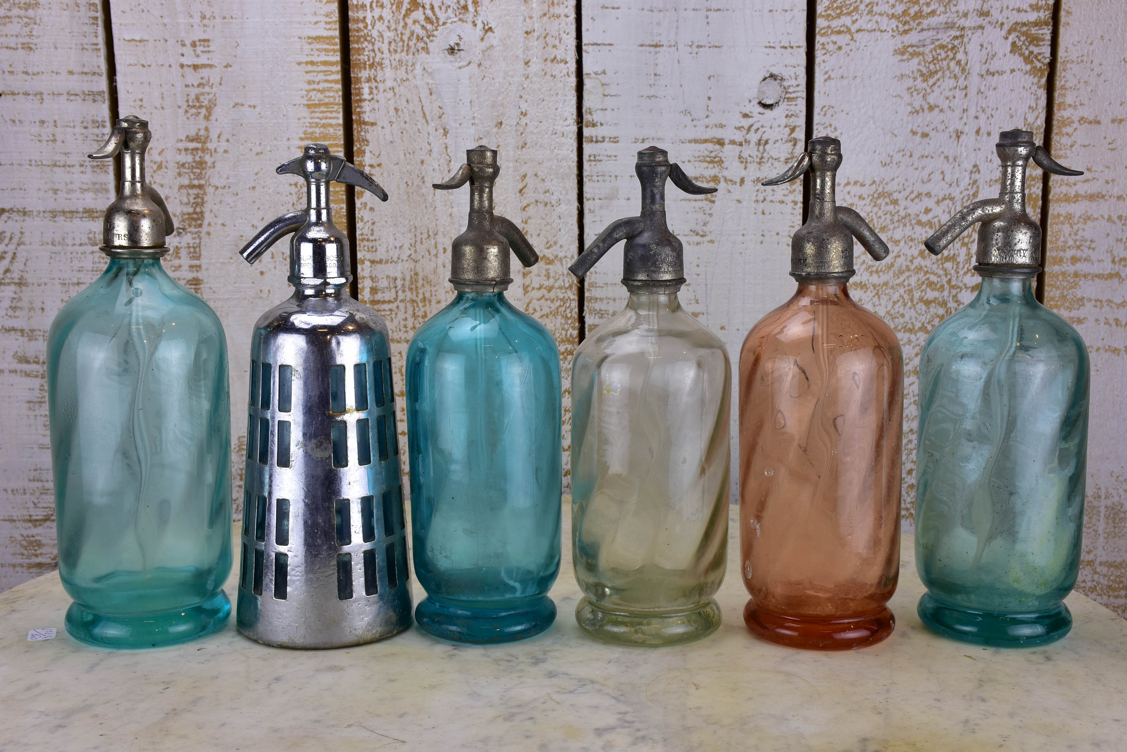 Twelve antique French seltzer bottles