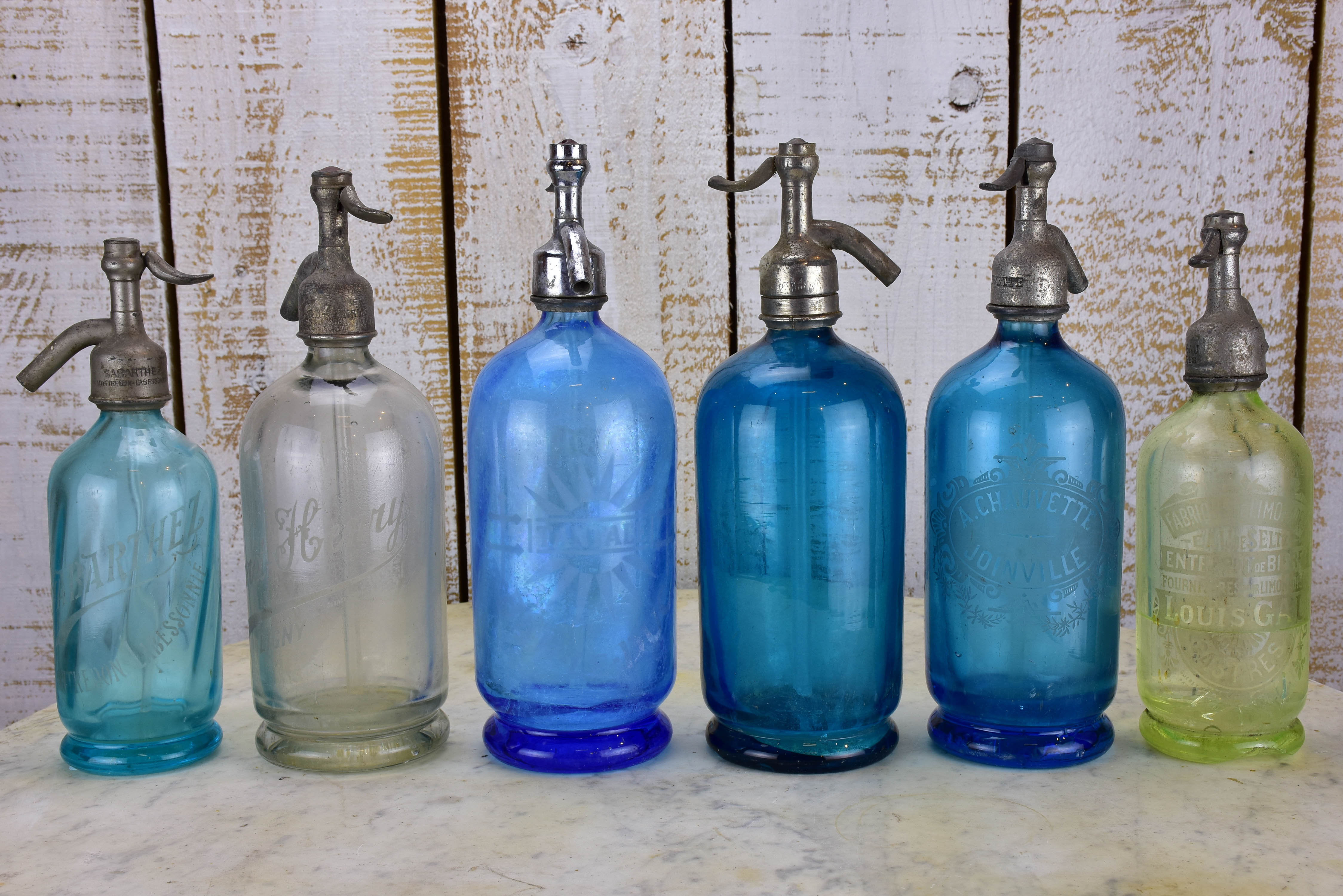 Twelve antique French seltzer bottles