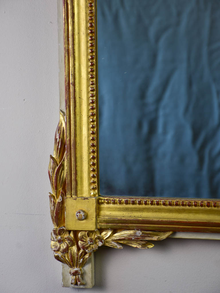 Louis XVI-style gilded mirror with musical floral crest and motifs 26½" x 46¾"