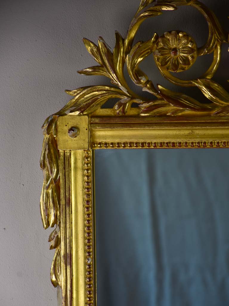 Louis XVI-style gilded mirror with musical floral crest and motifs 26½" x 46¾"