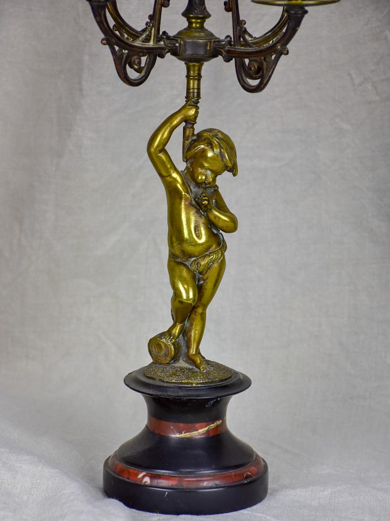 Pair of Napoleon III candlesticks with cherubs