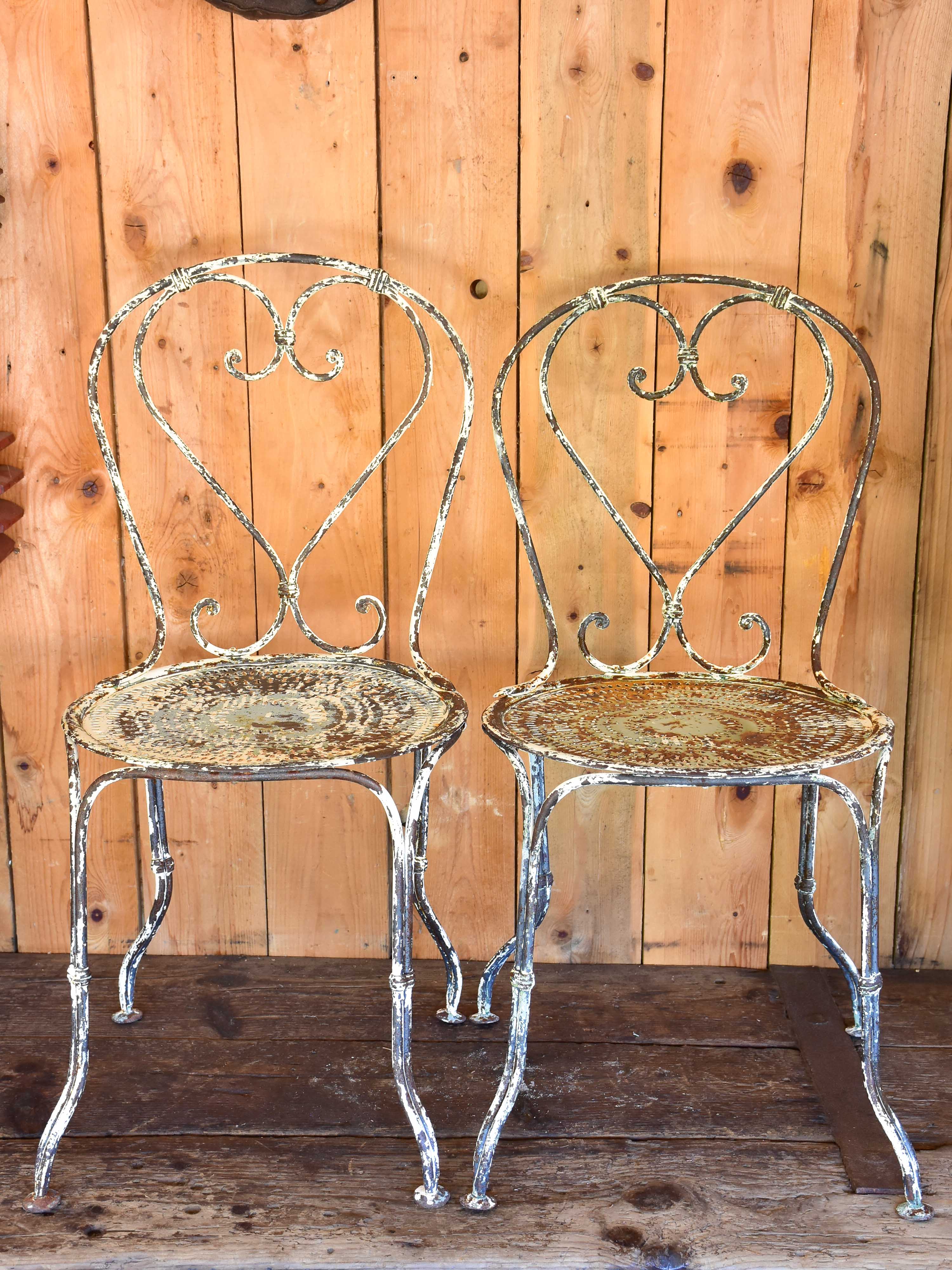 Pair of heart-backed antique French garden chairs