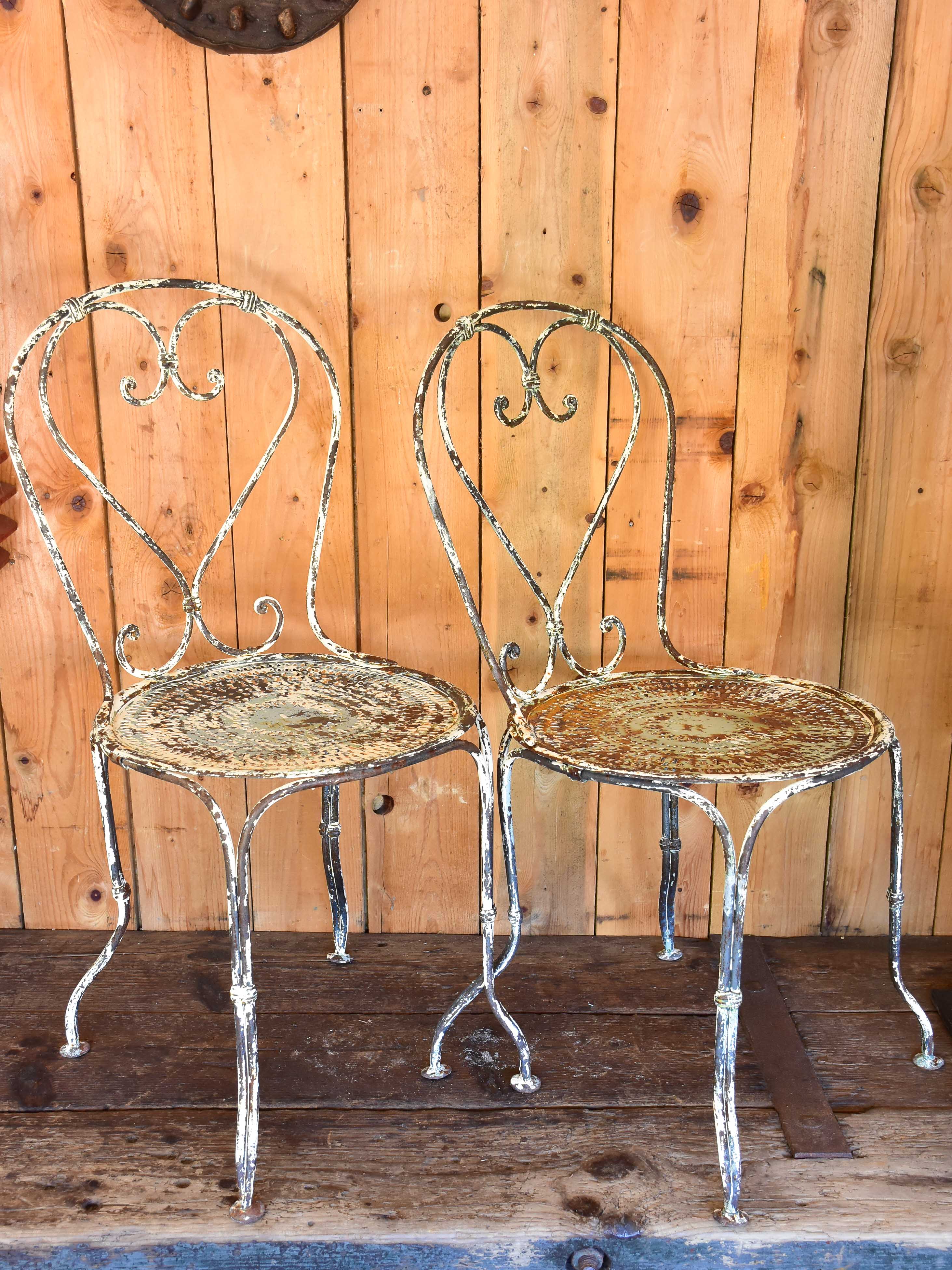 Pair of heart-backed antique French garden chairs