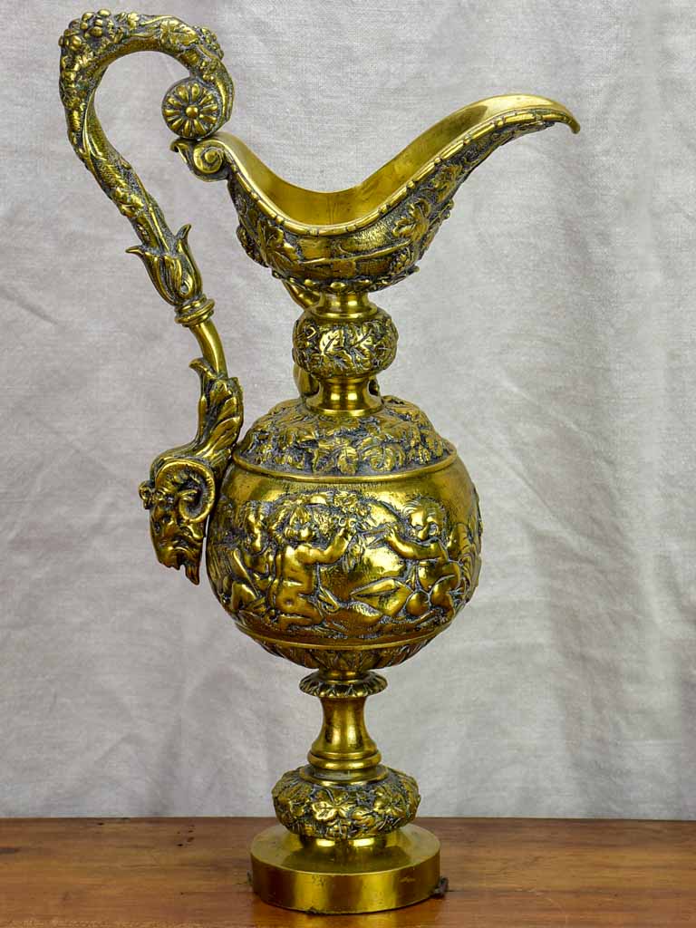 Bronze Napoleon III pitcher adorned with foliage, fruit and a cherub 17¾"