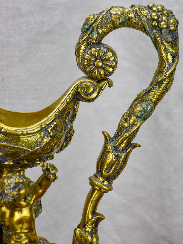 Bronze Napoleon III pitcher adorned with foliage, fruit and a cherub 17¾"