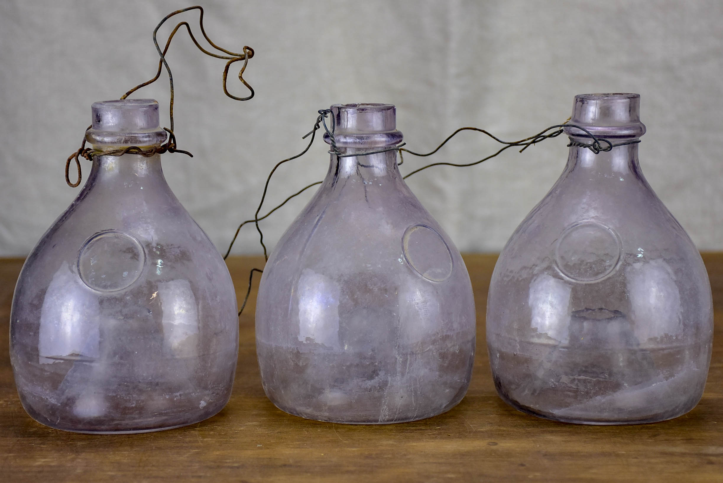 Three antique French fly-trap bottles - purple tinge