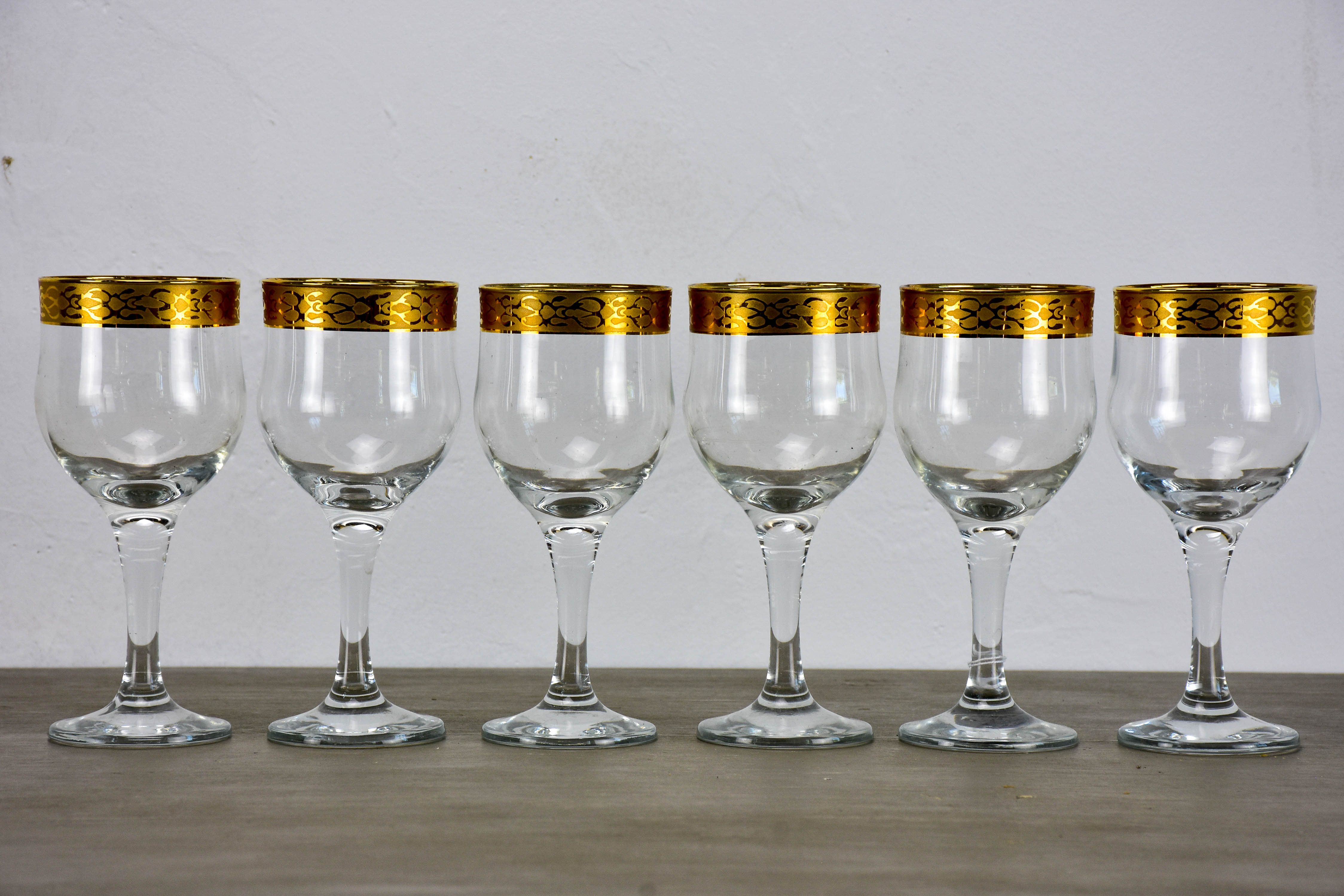 Six antique French wine glasses with gold rim