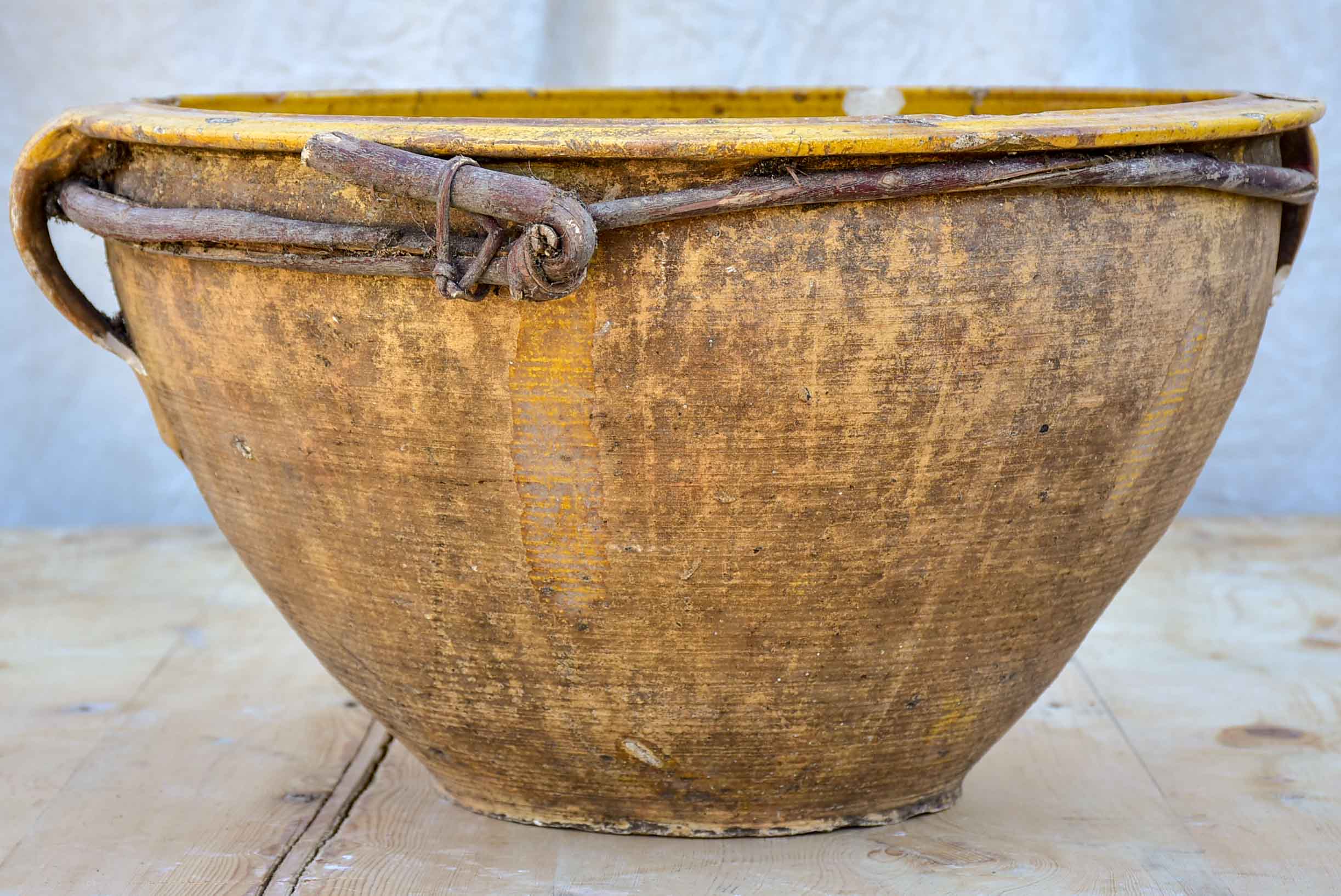 Large antique terracotta bowl with yellow glaze