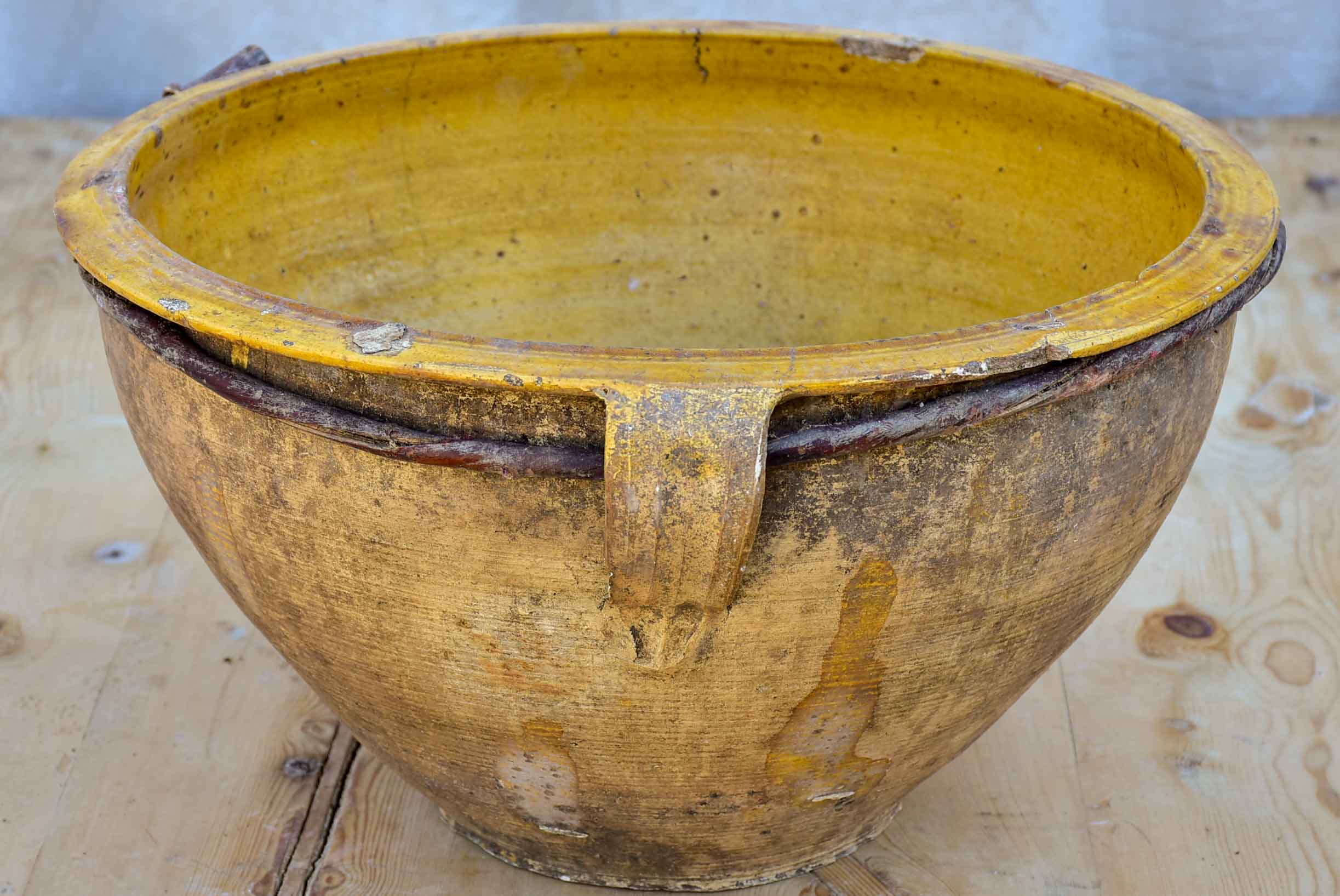 Large antique terracotta bowl with yellow glaze