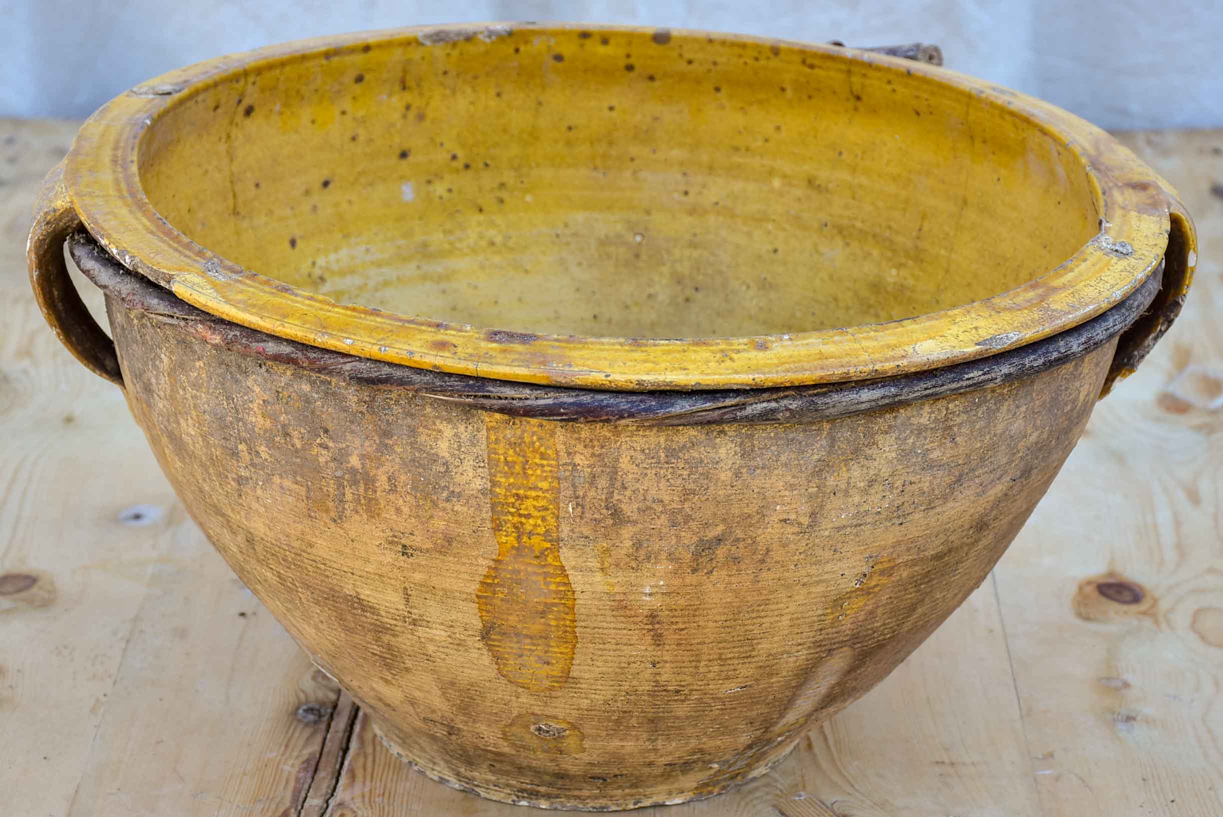 Large antique terracotta bowl with yellow glaze