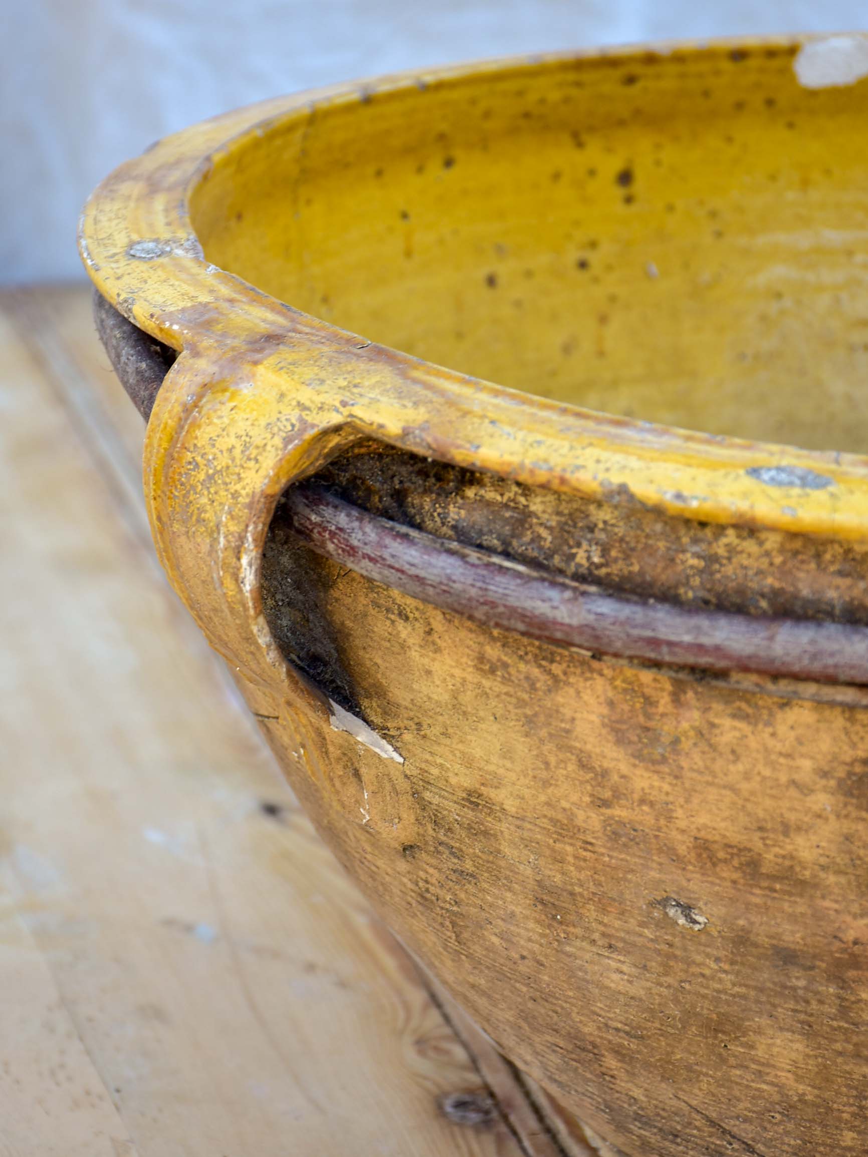 Large antique terracotta bowl with yellow glaze