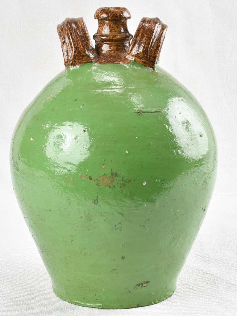 Antique water jug with green paint finish