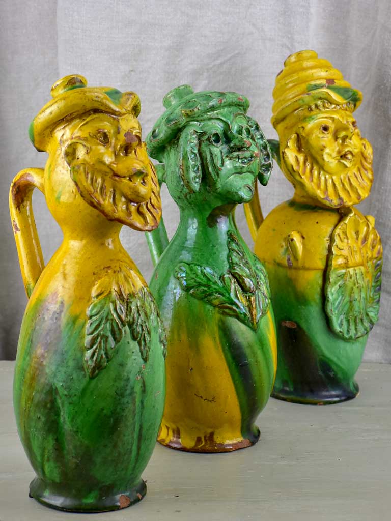 Three antique folk art pitchers with yellow and green glaze