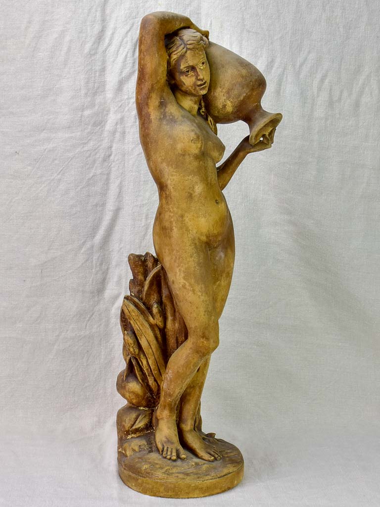 Antique terracotta sculpture of a woman holding a vase 29½"