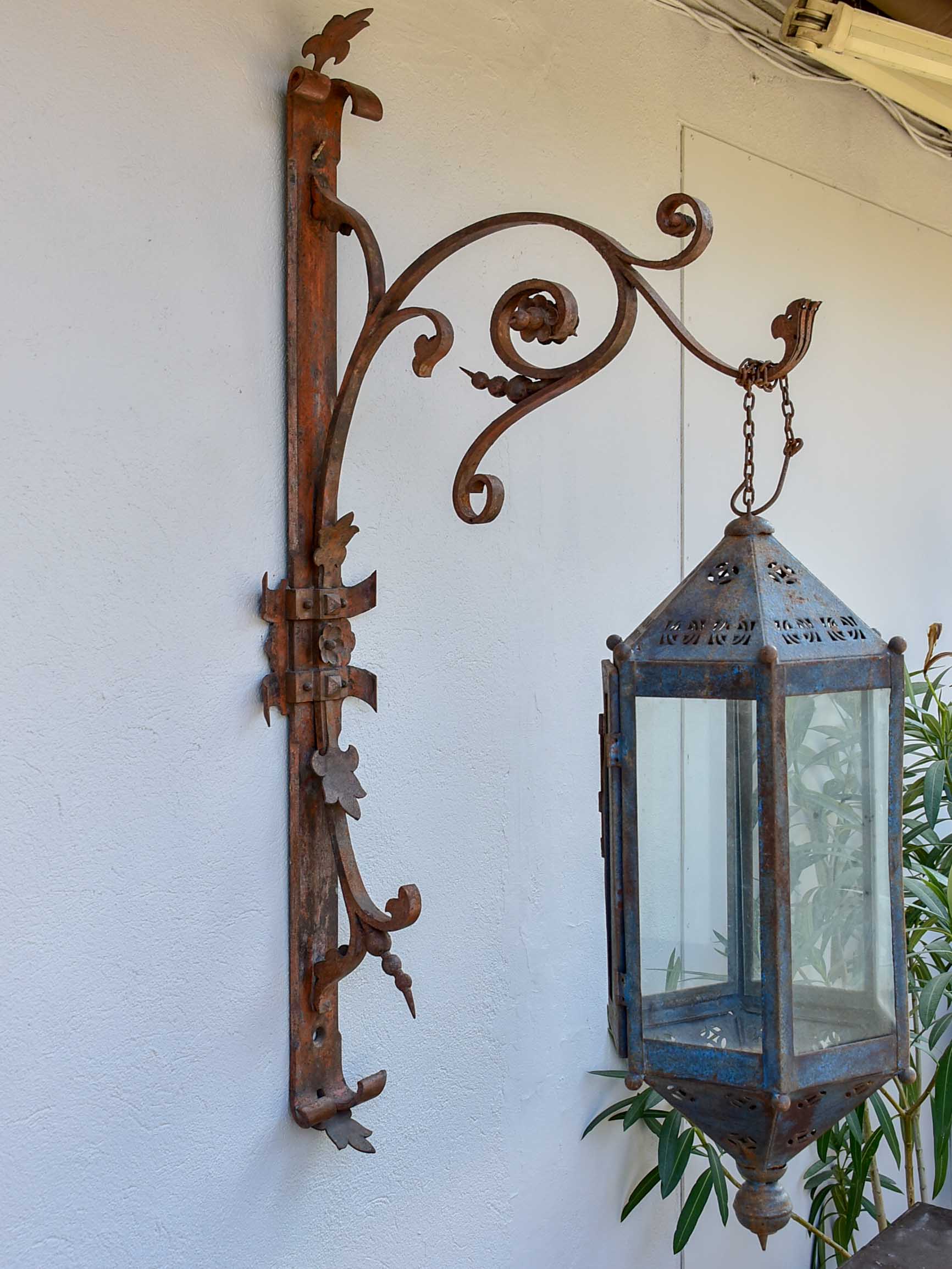 Antique lantern with large wrought iron wall bracket