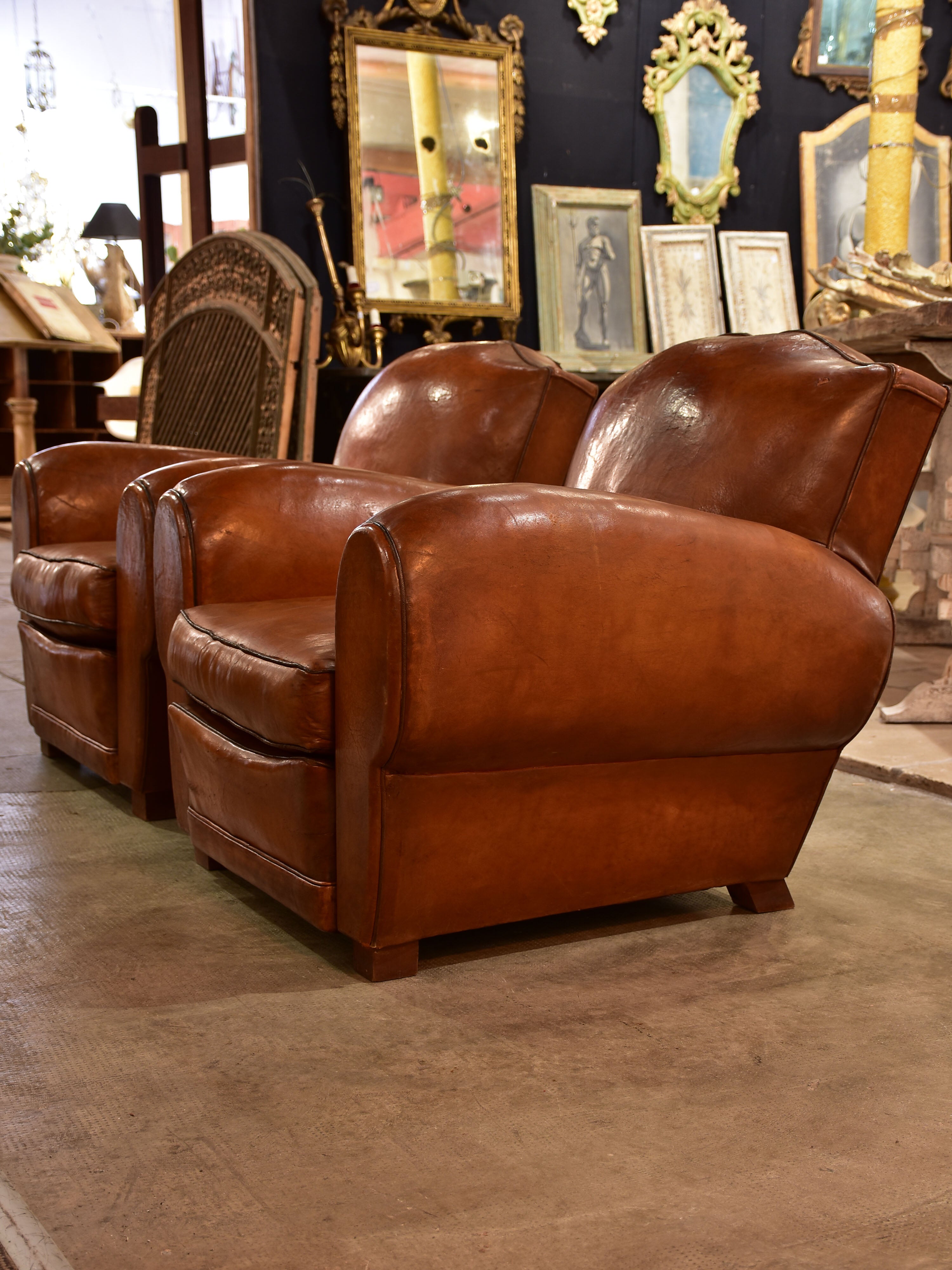 Pair of large moustache back French leather club chairs