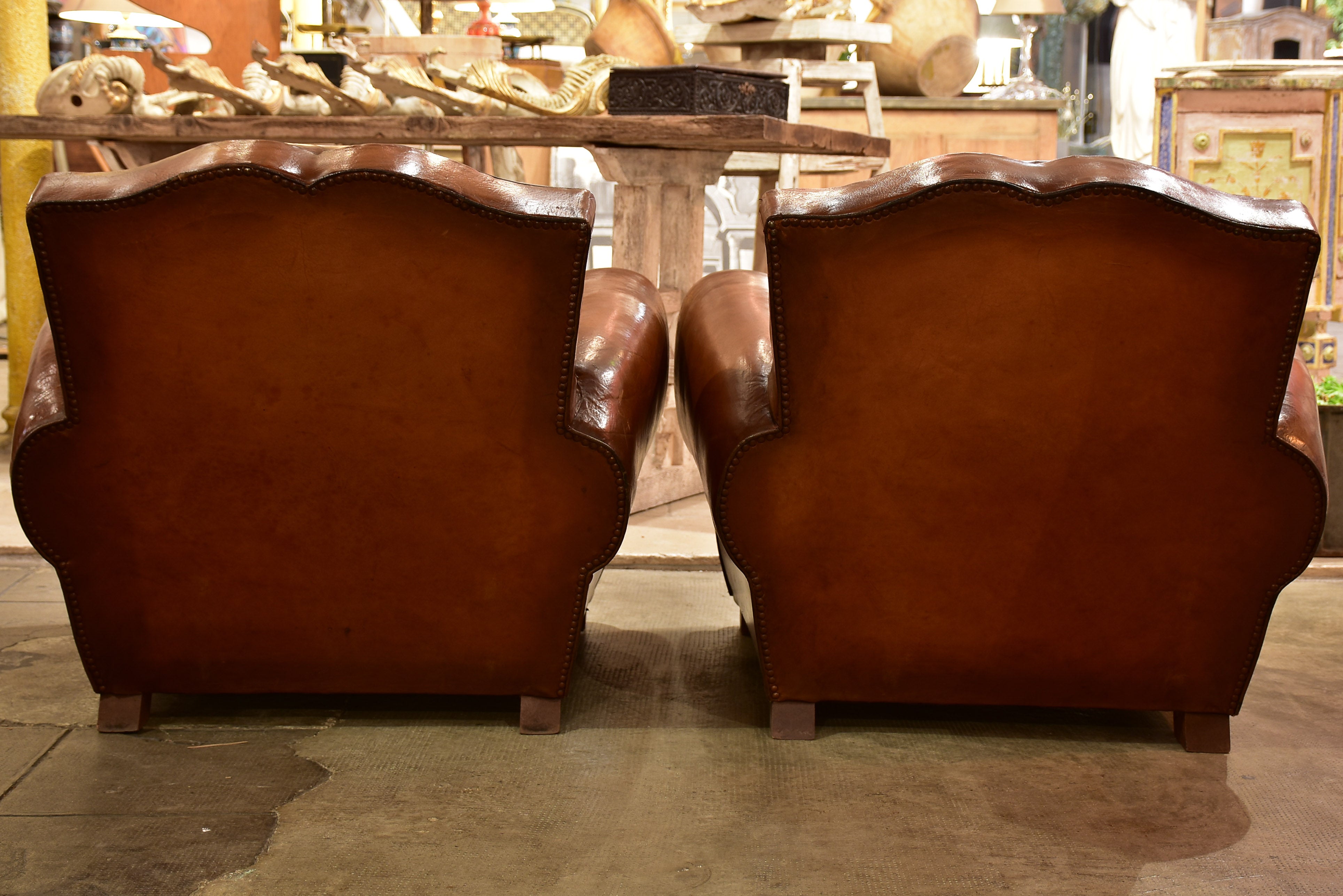 Pair of large moustache back French leather club chairs