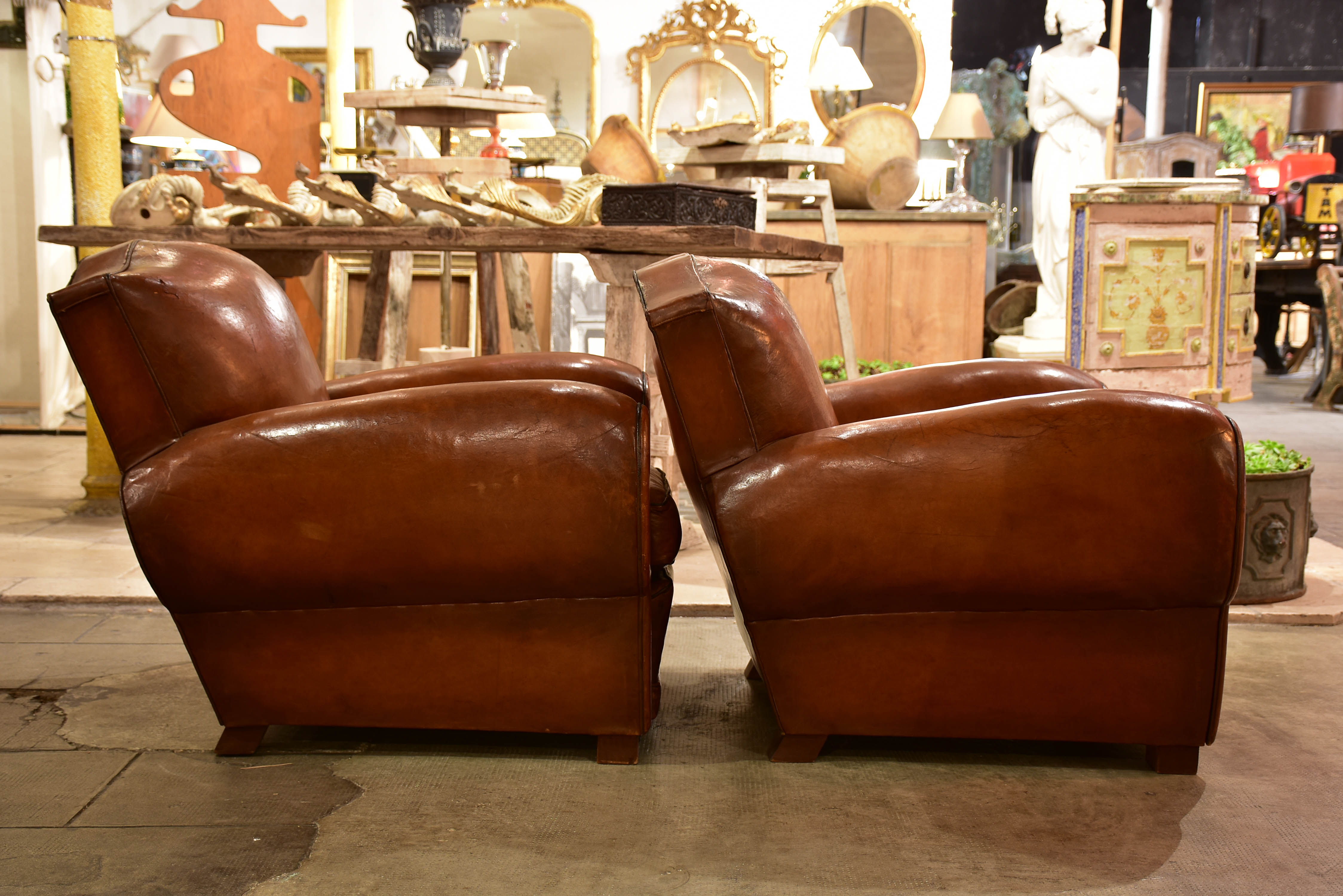 Pair of large moustache back French leather club chairs