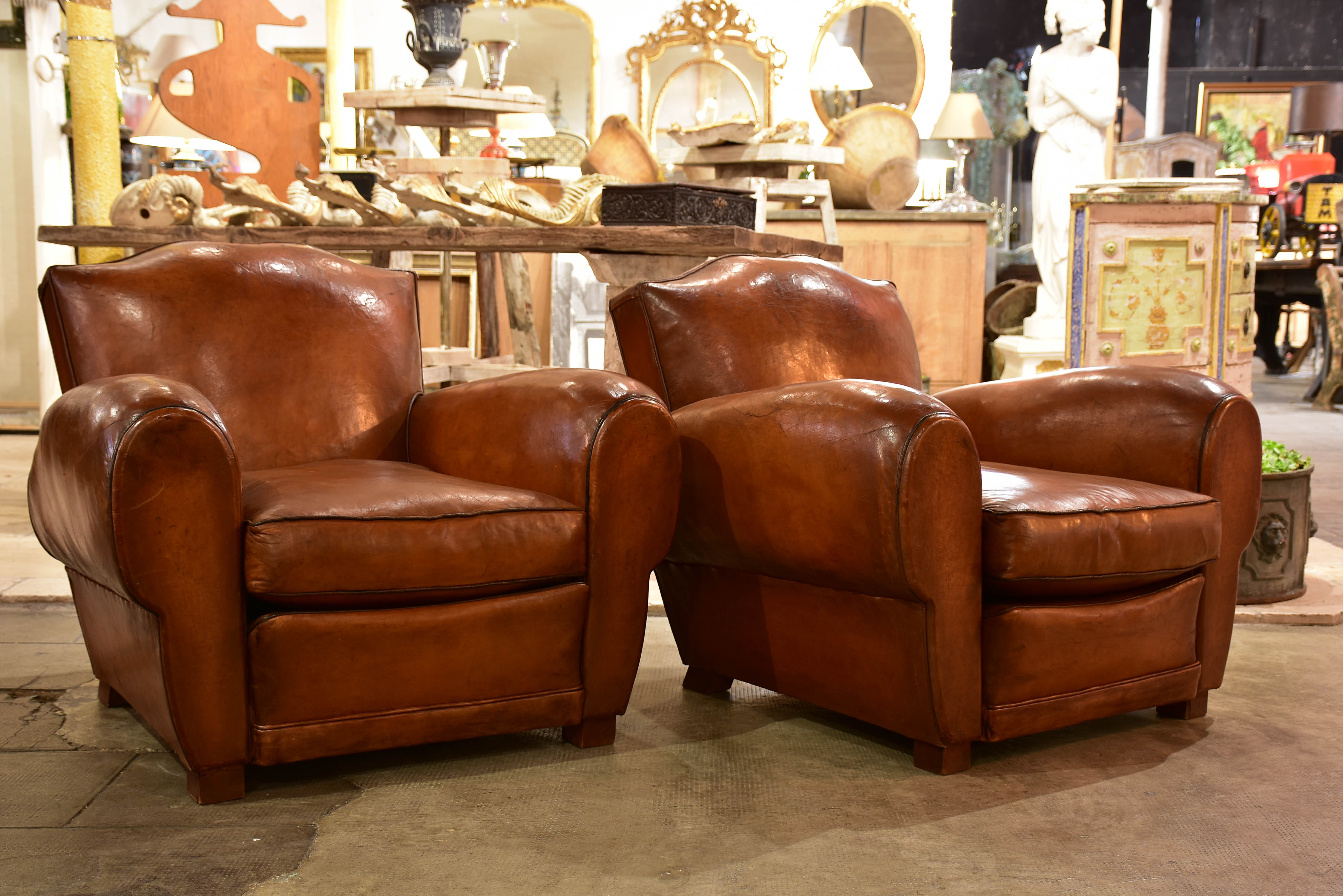 Pair of large moustache back French leather club chairs