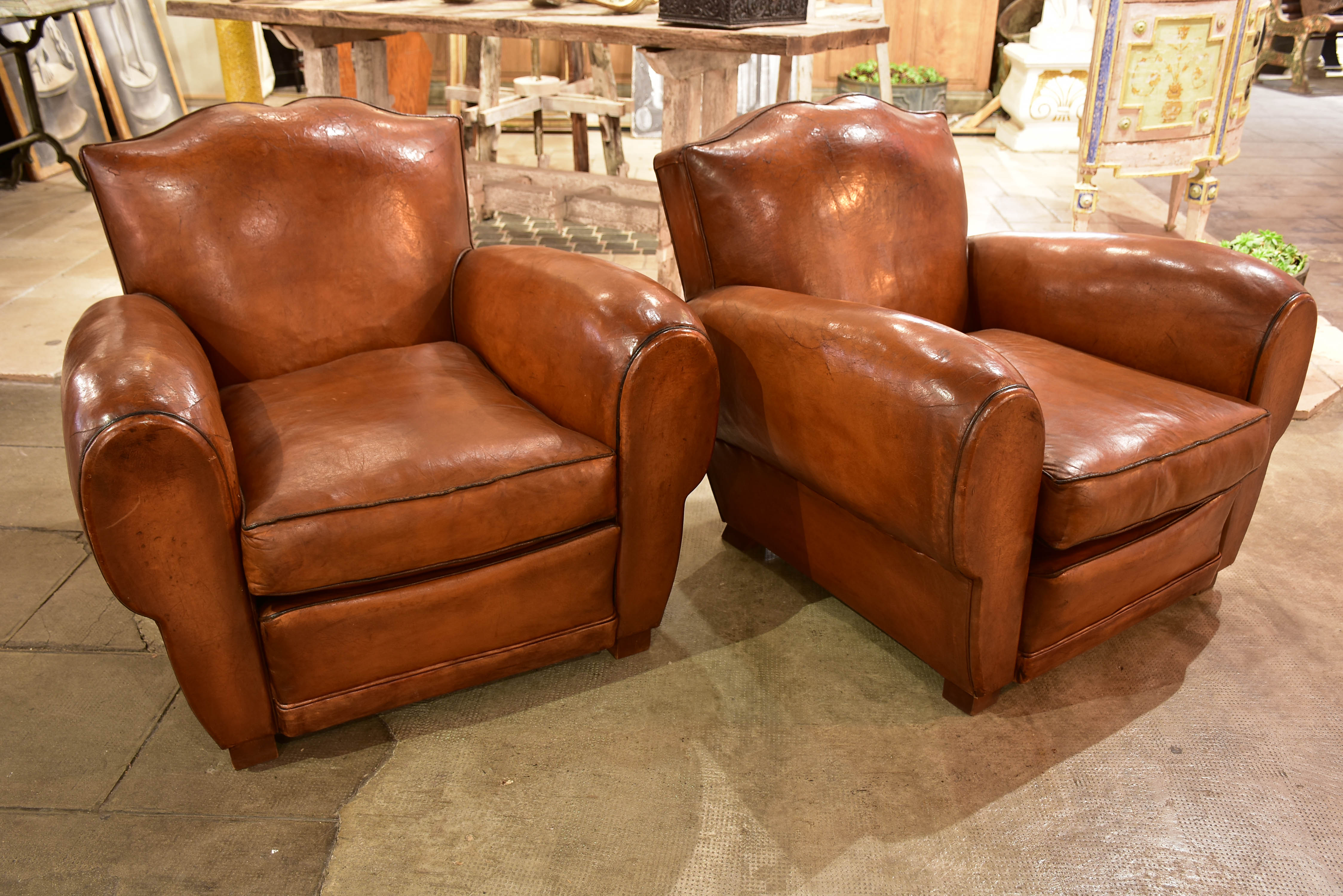 Pair of large moustache back French leather club chairs