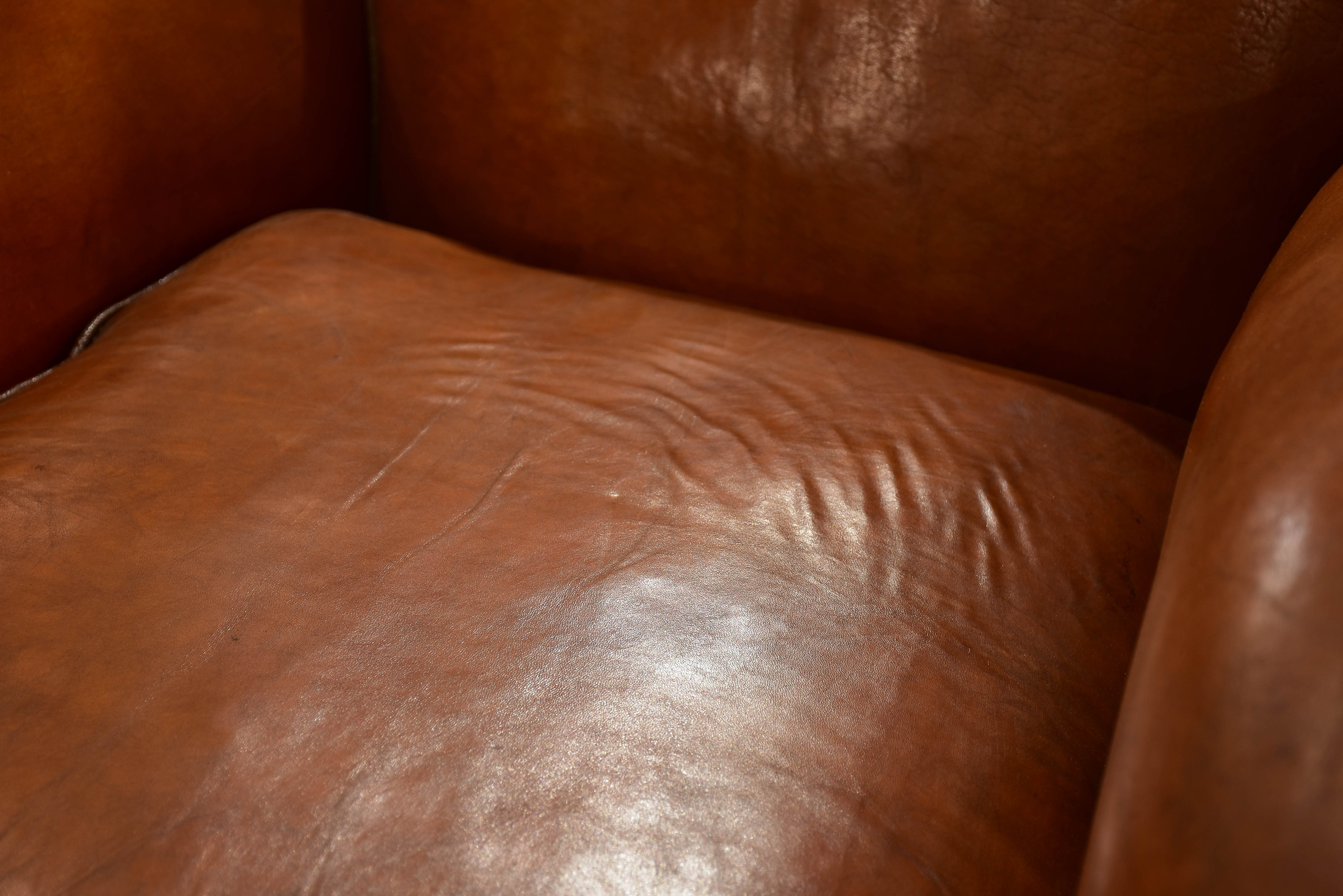 Pair of large moustache back French leather club chairs