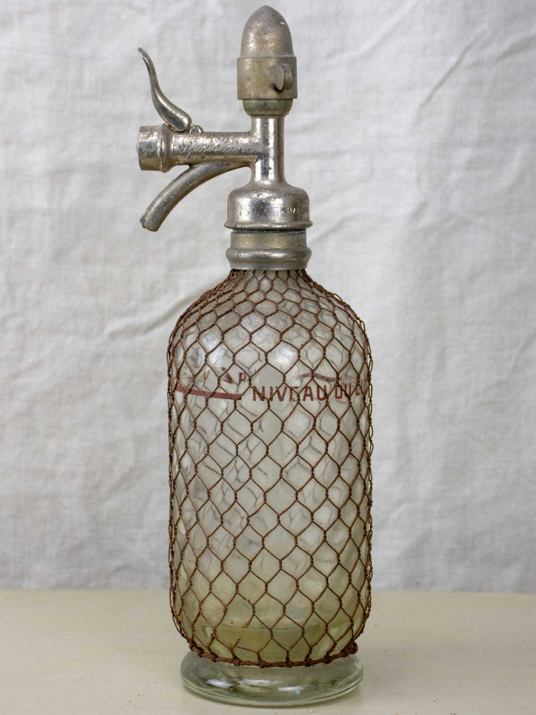 Antique French Sparklets Seltzer bottle with metal wiring