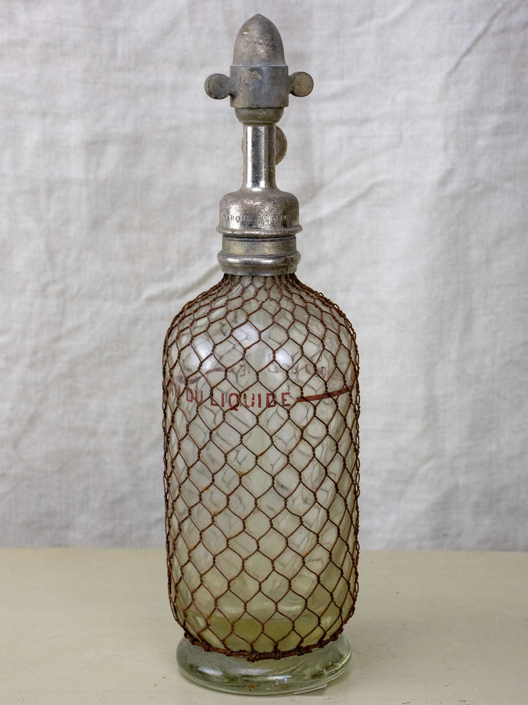 Antique French Sparklets Seltzer bottle with metal wiring