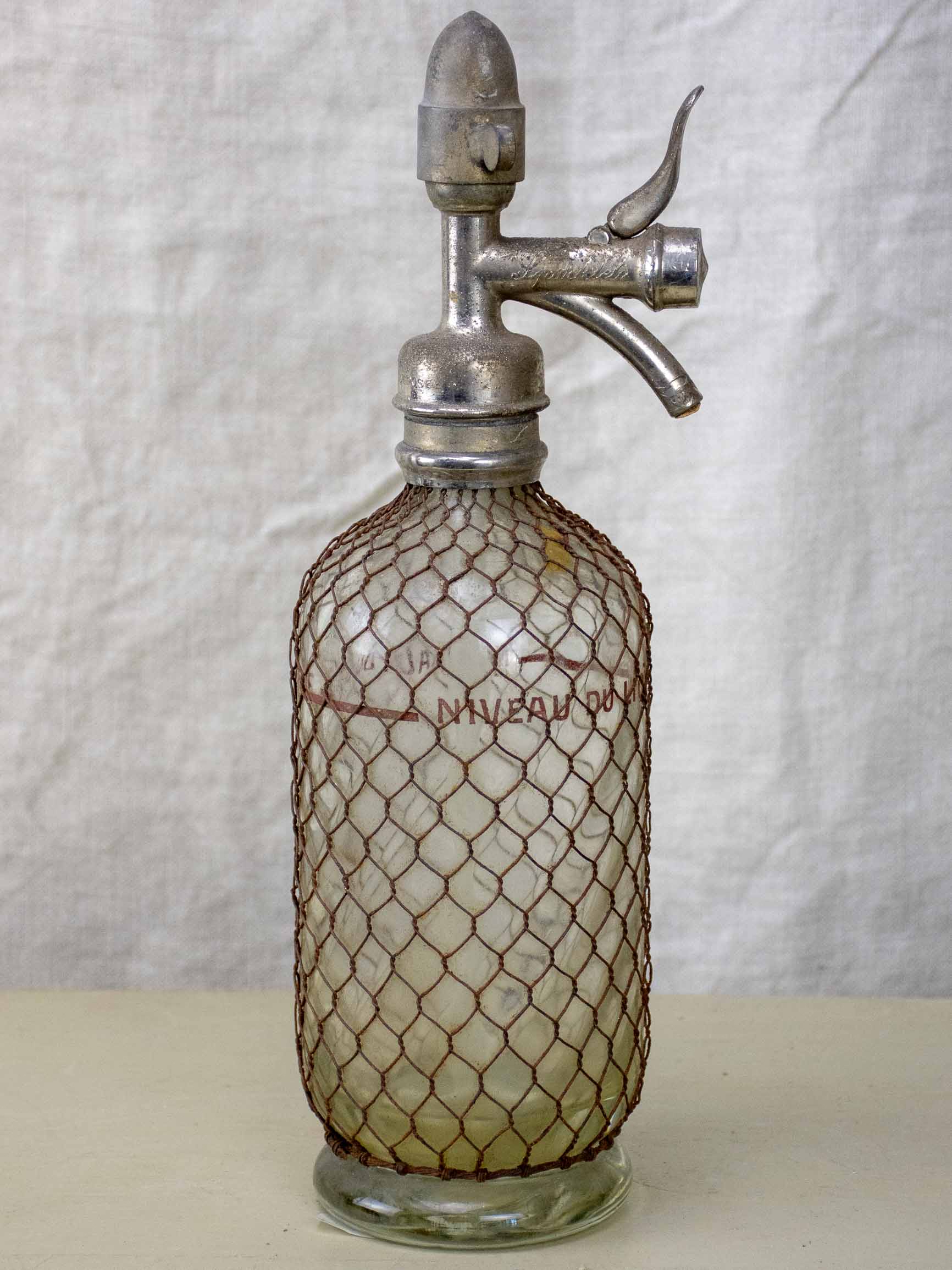 Antique French Sparklets Seltzer bottle with metal wiring