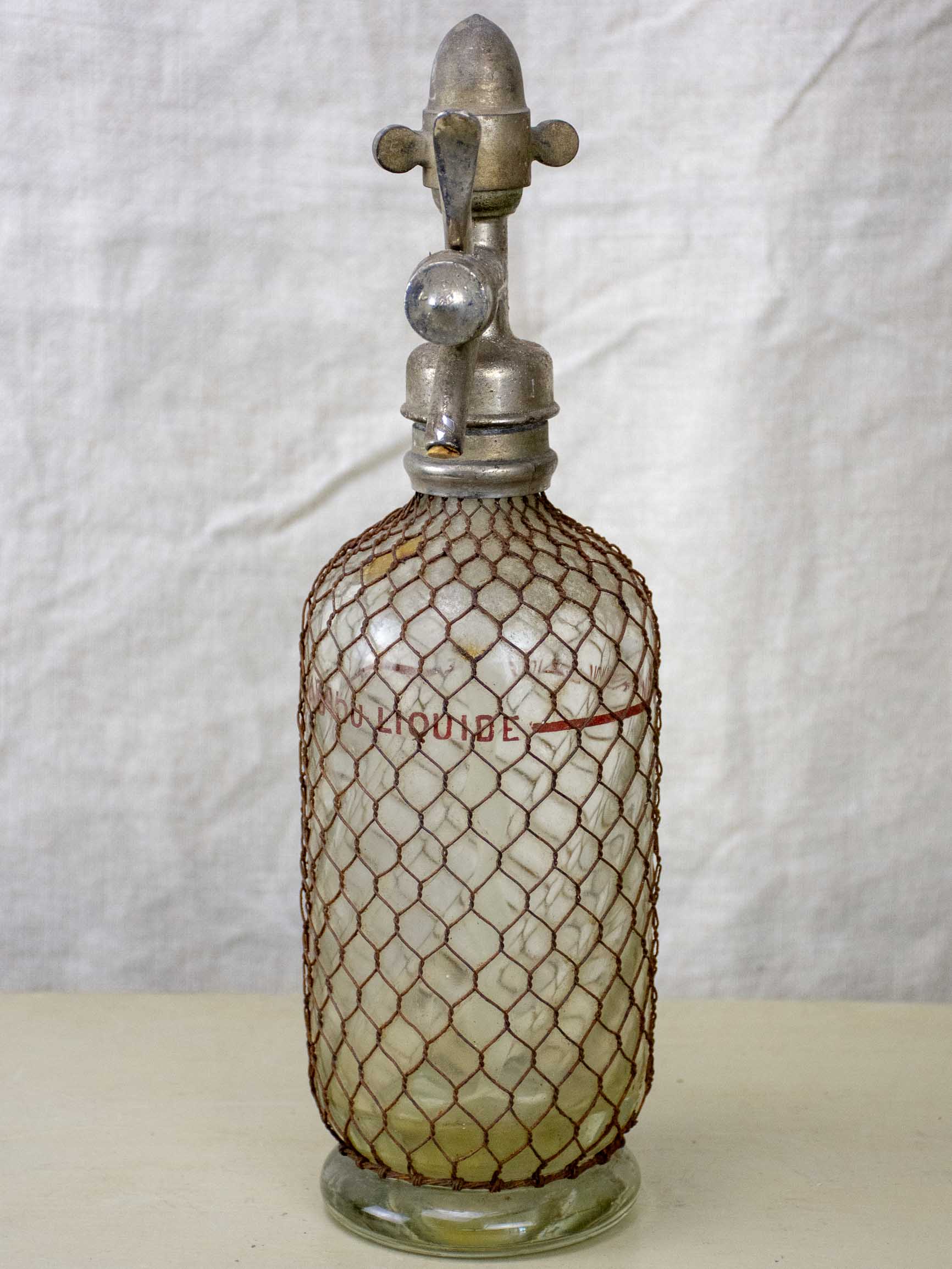 Antique French Sparklets Seltzer bottle with metal wiring