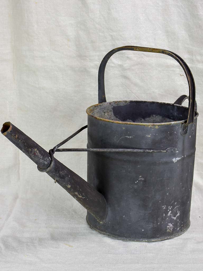 Antique English watering can with black painted finish