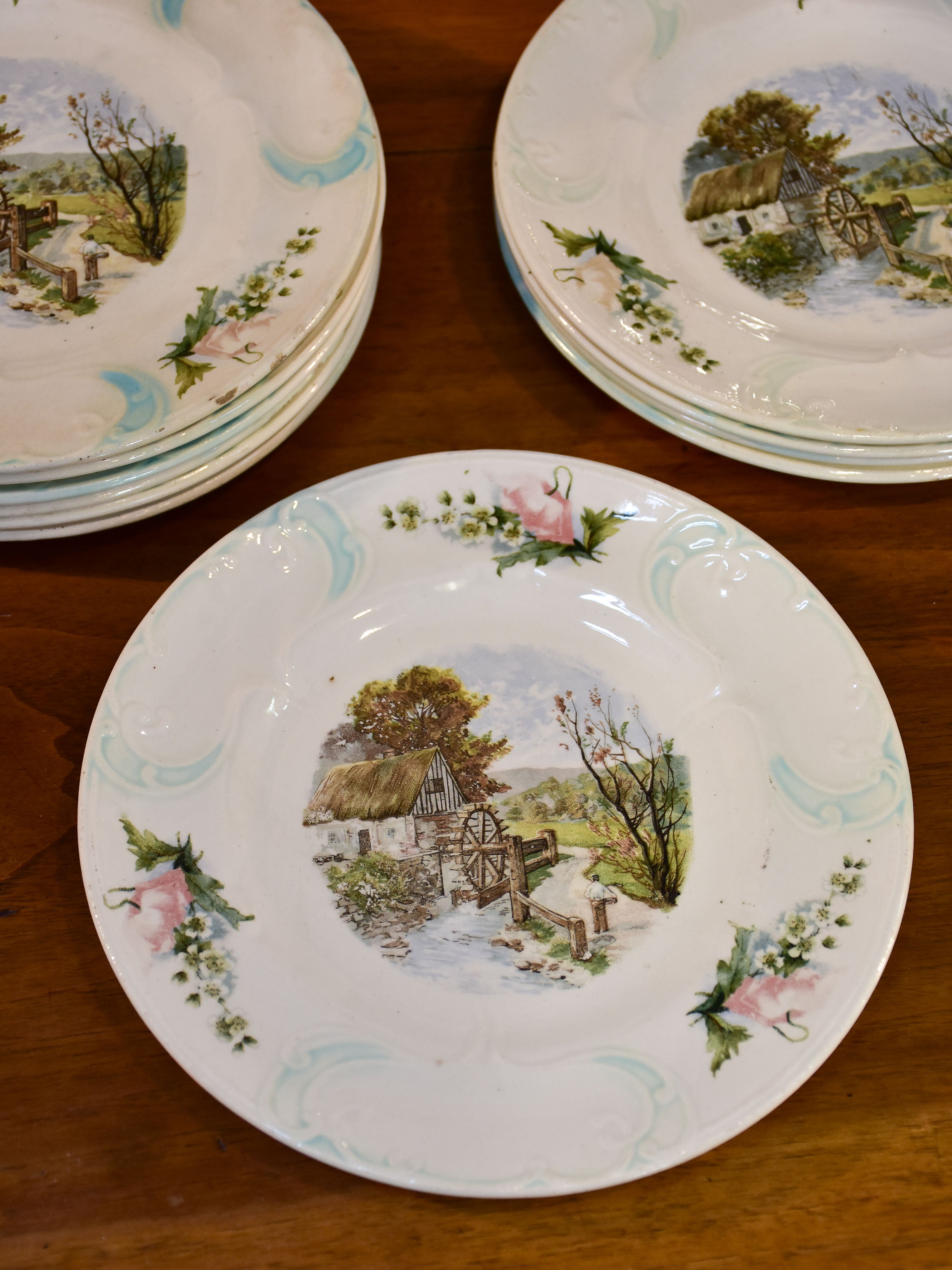 11 French faïence earthernware plates with country scene