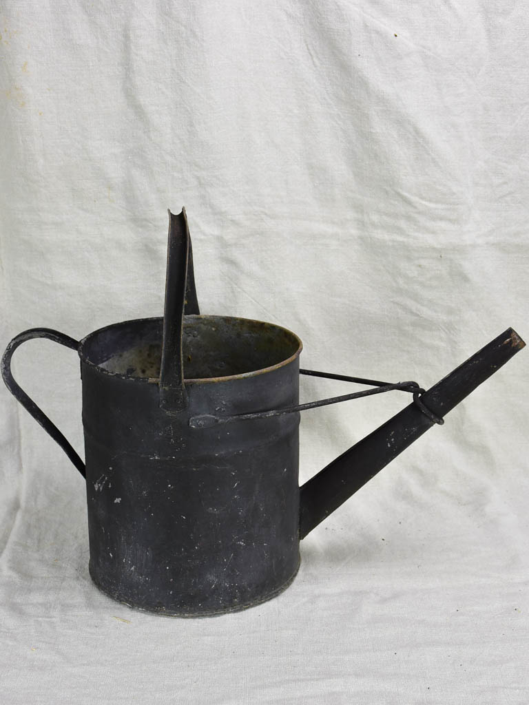 Antique English watering can with black painted finish