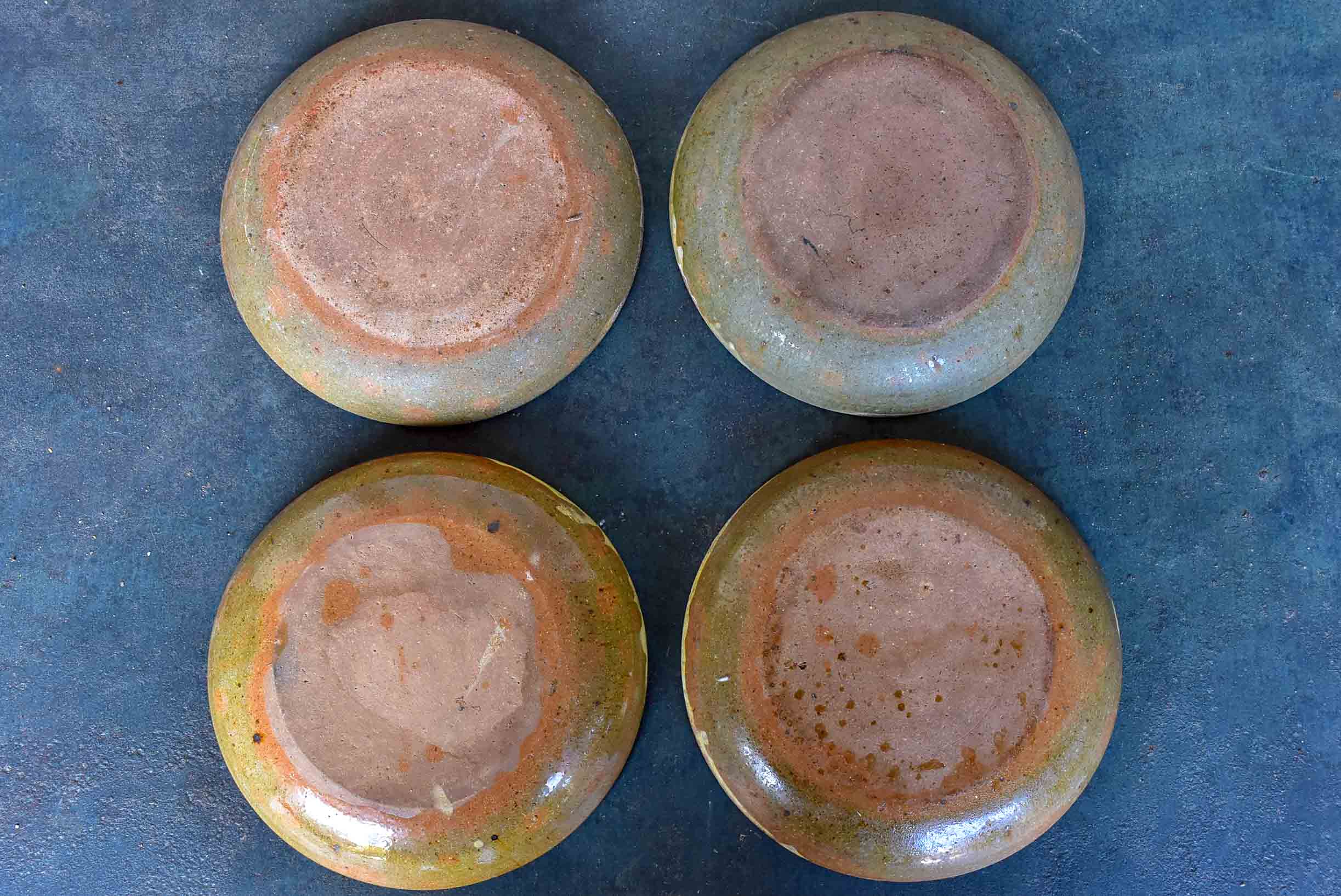 Four rustic French terracotta plates