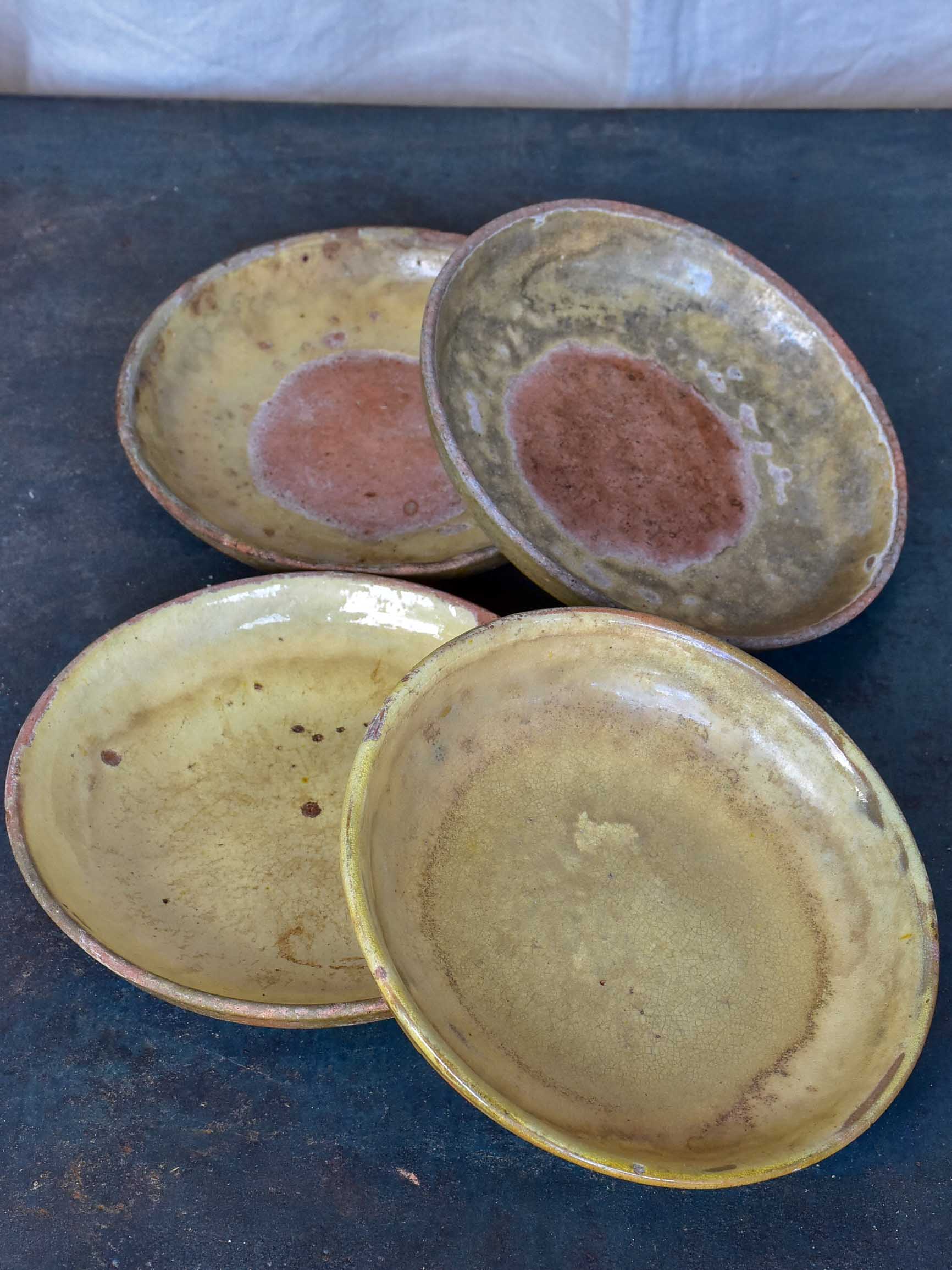 Four rustic French terracotta plates