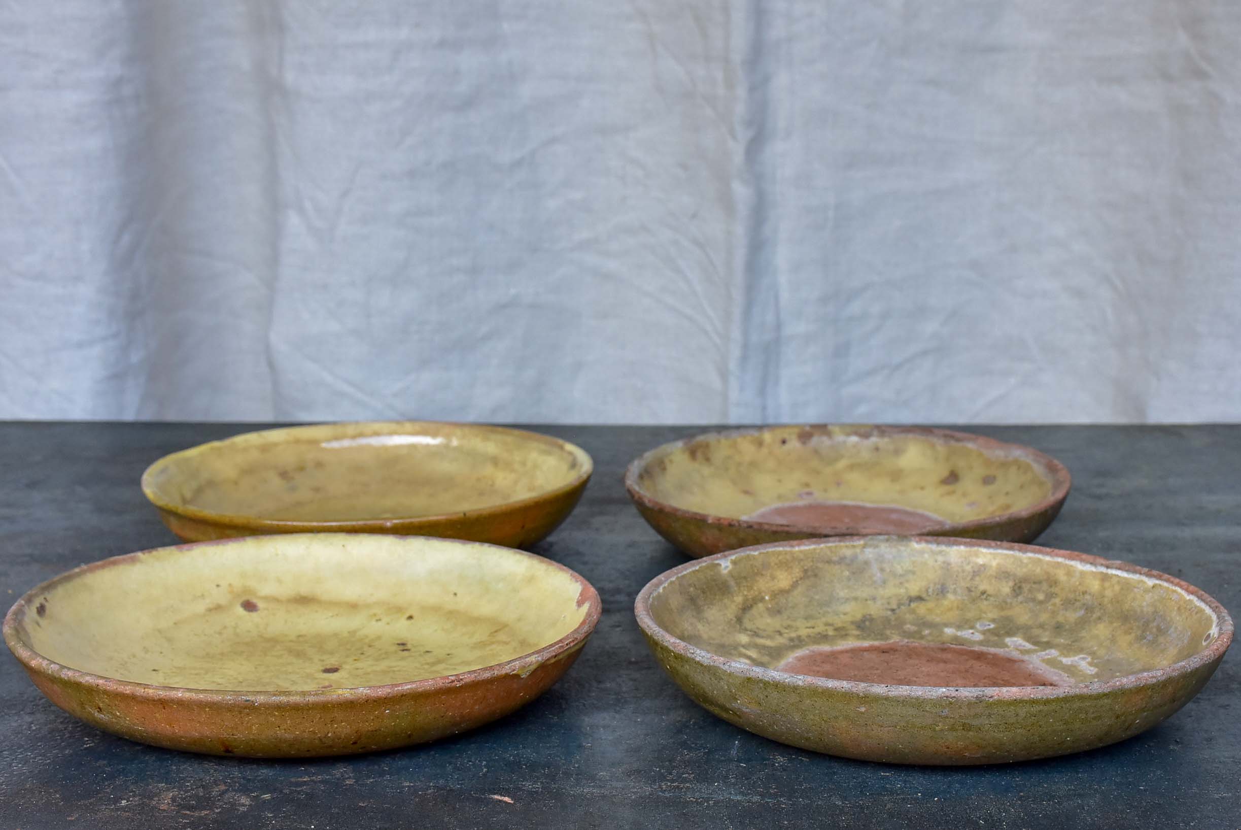 Four rustic French terracotta plates