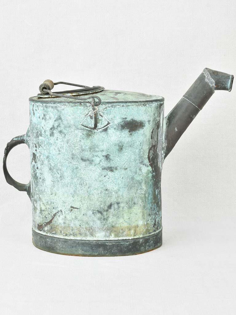 Antique French watering can with blue green atina