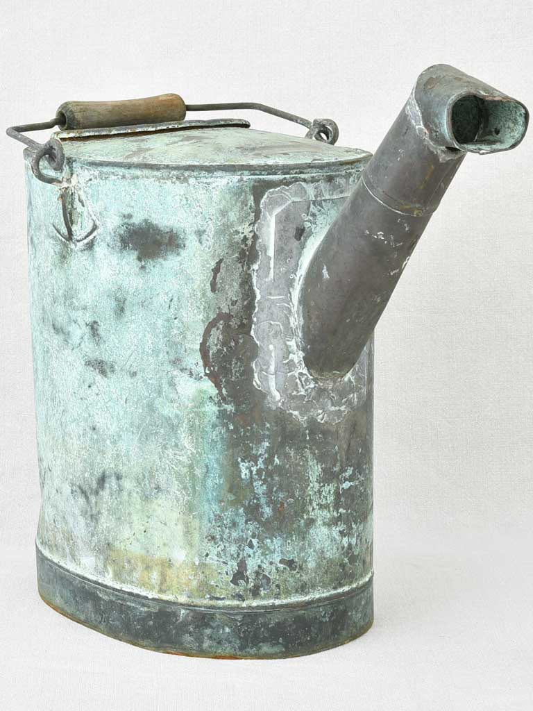 Antique French watering can with blue green atina