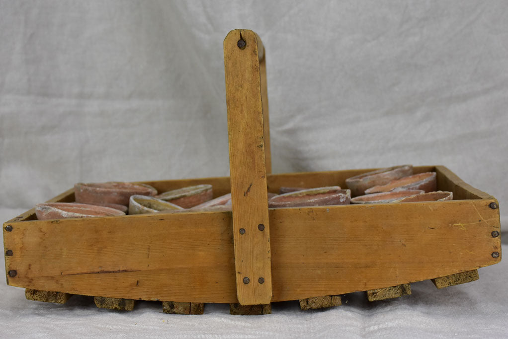 Antique French wooden potato harvest basket with terracotta pots