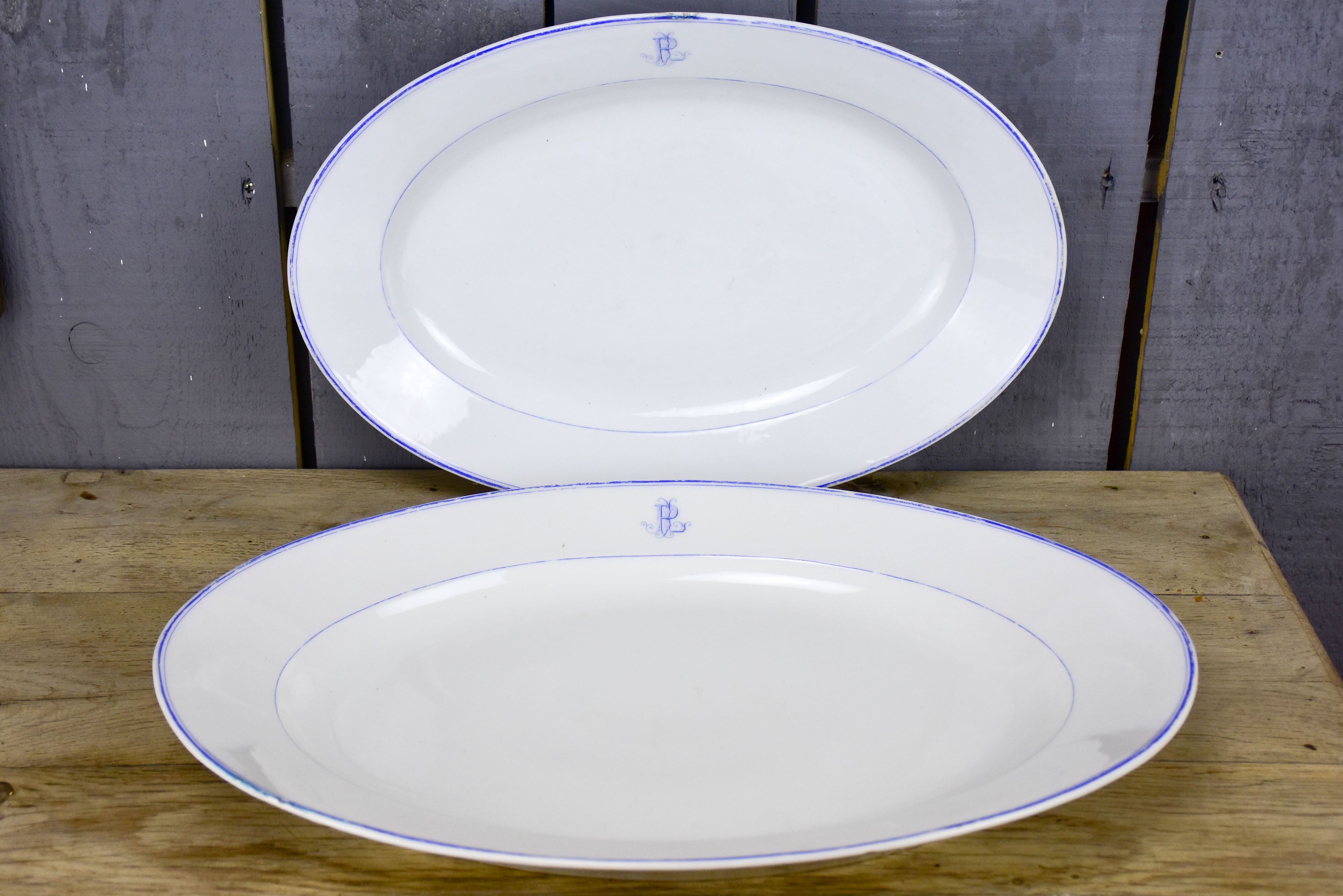 Two faïence platters with PL monogram