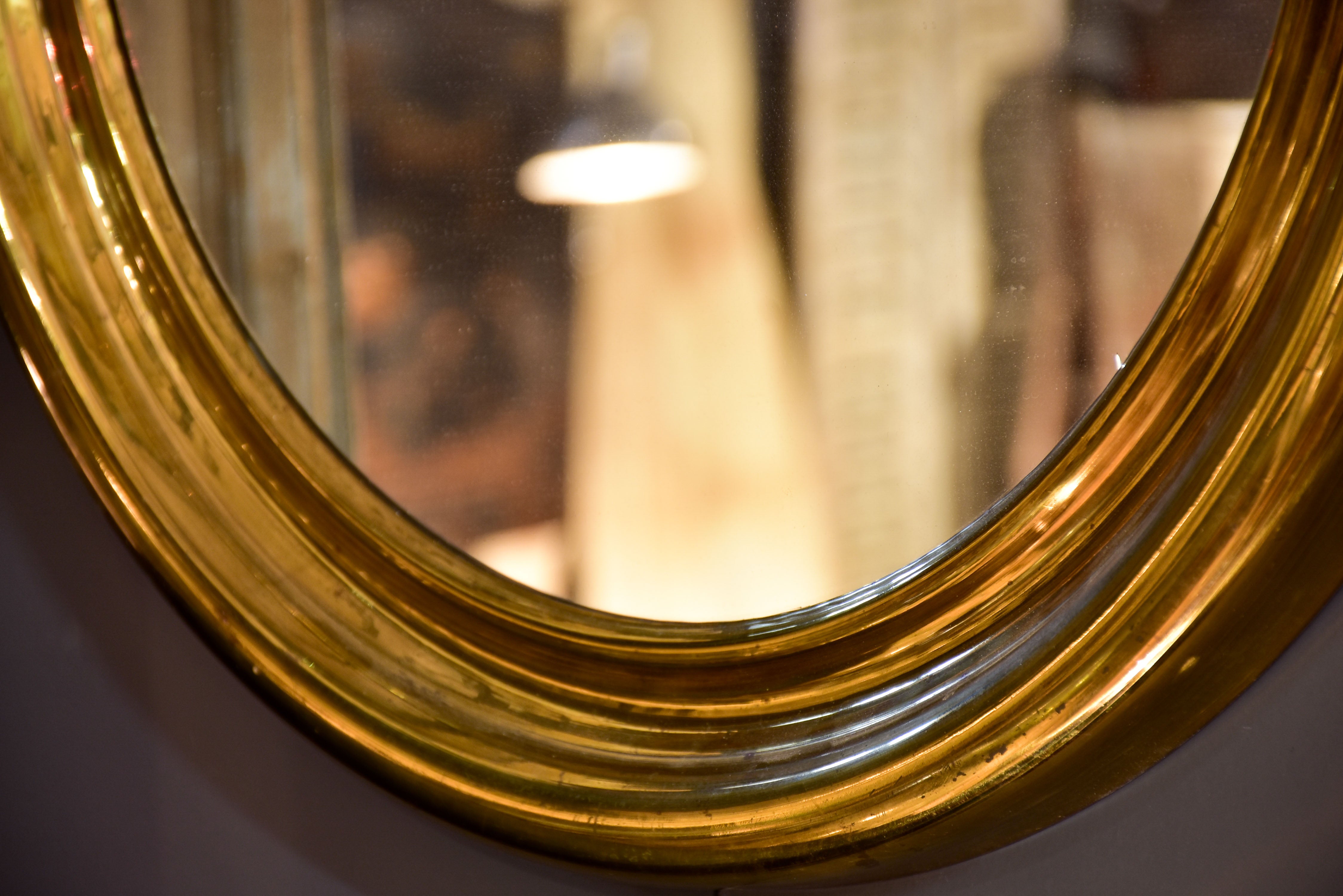 Round vintage French mirror with gold brass frame